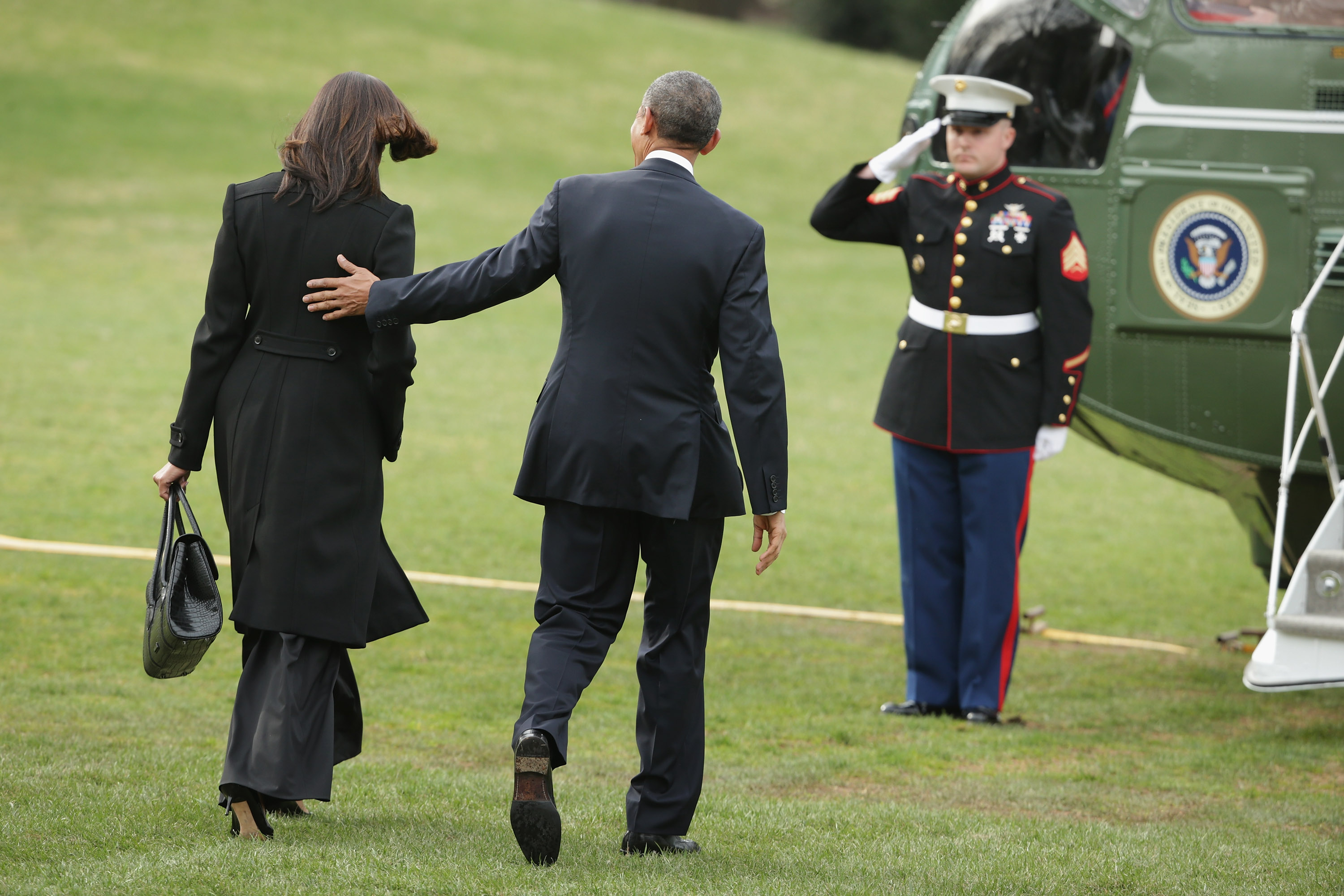 Michelle and Barack Obama walking across the South Lawn before boarding Marine One and departing the White House on March 30, 2015, in Washington, D.C. | Source: Getty Images