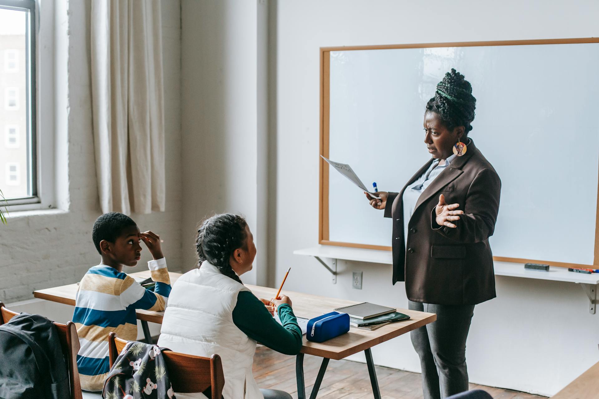 A female teacher with pupils in a classroom | Source: Pexels