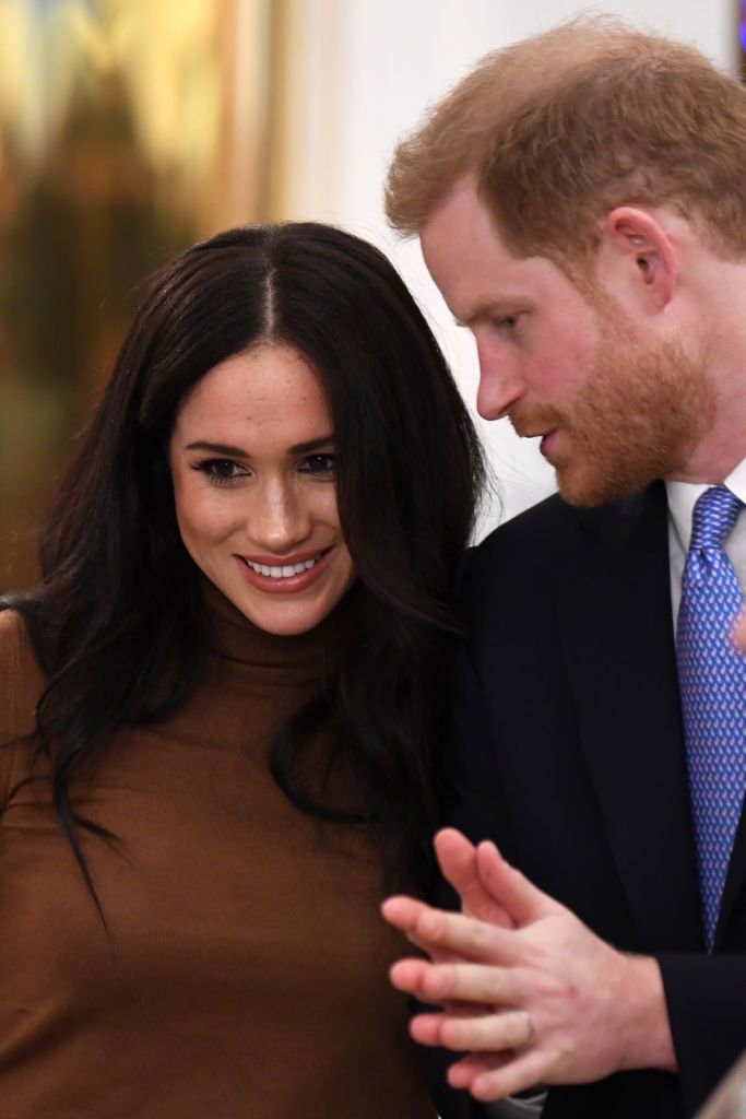 Prince Harry, Duke of Sussex and Meghan, Duchess of Sussex gesture during their visit to Canada House in thanks for the warm Canadian hospitality and support they received during their recent stay in Canada, | Photo: Getty Images