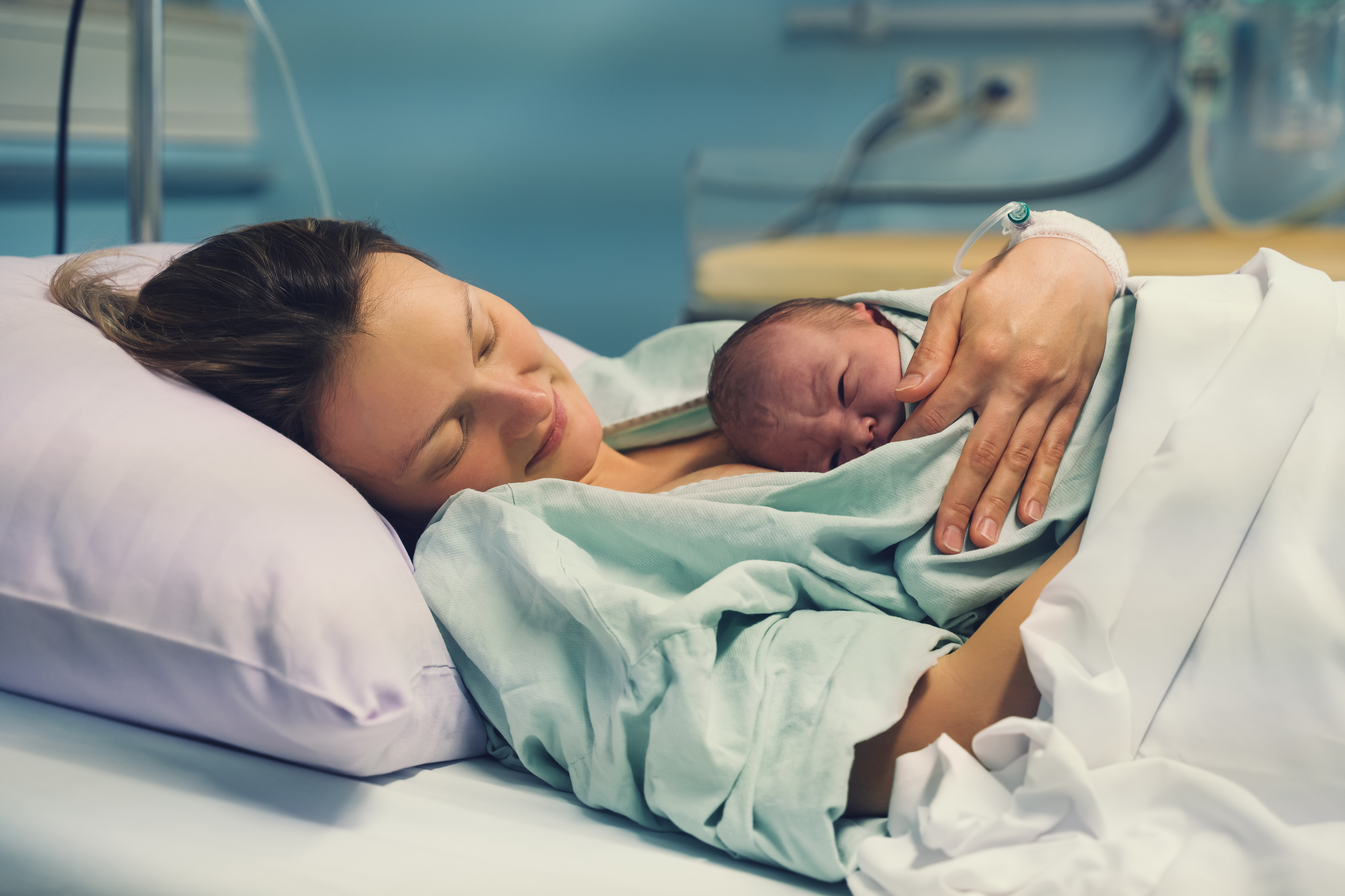 A mother with her newborn baby in hospital | Source: Shutterstock