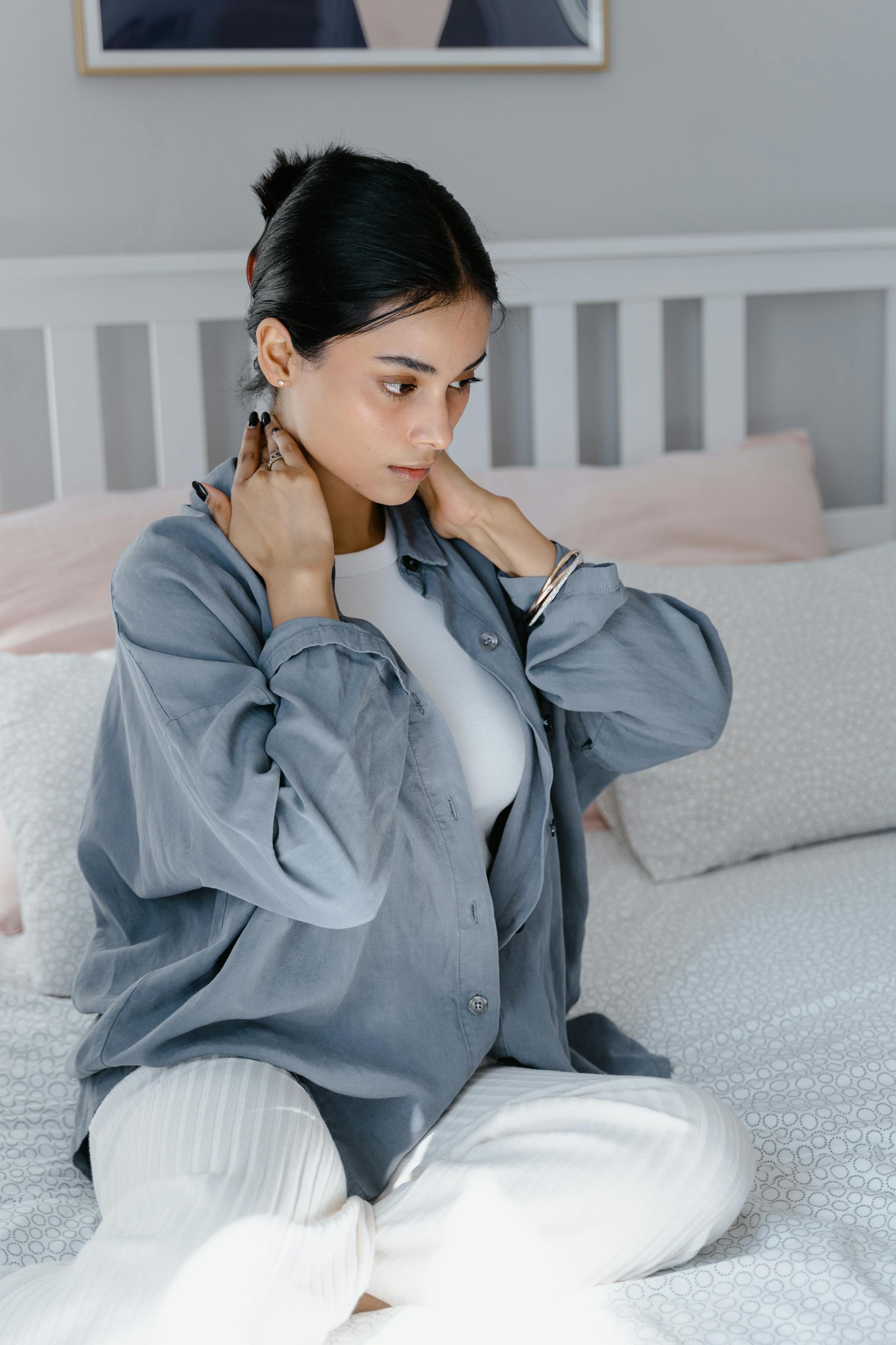 A woman sitting on the bed | Source: Pexels