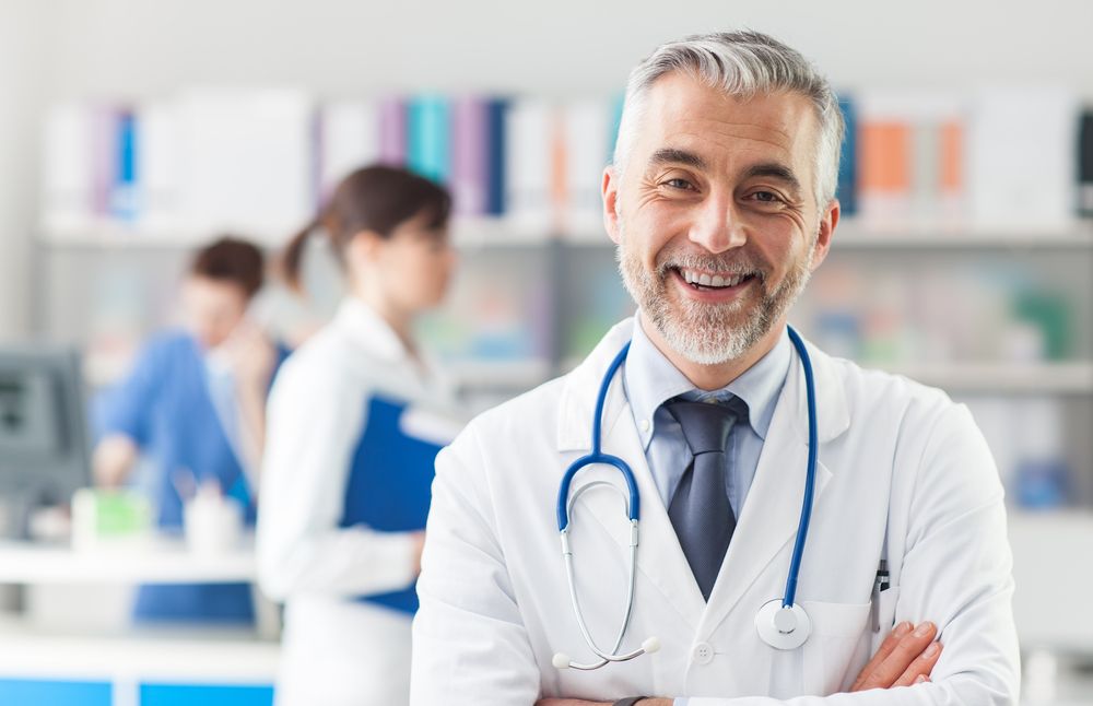 A doctor smiles at the camera. | Source: Shutterstock