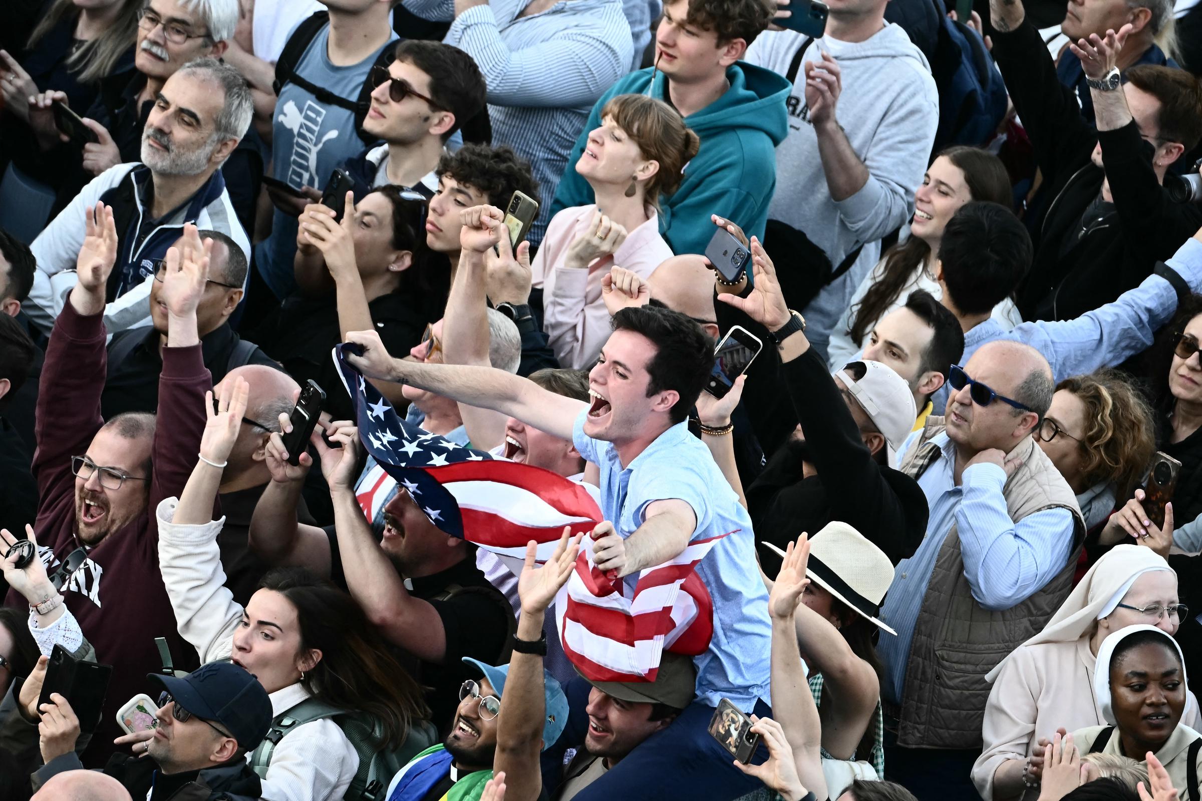 A man waves a U.S. flag in St. Peter's Square as the new pope is announced in the Vatican on May 8, 2025 | Source: Getty Images