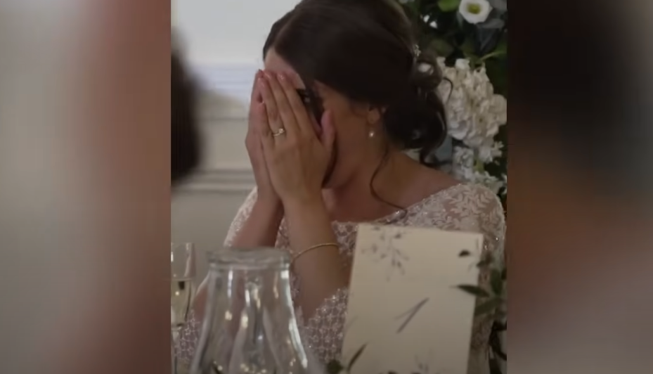 New bride Katie covering her face while Ian Young delivers his speech | Source: YouTube / Daily Record