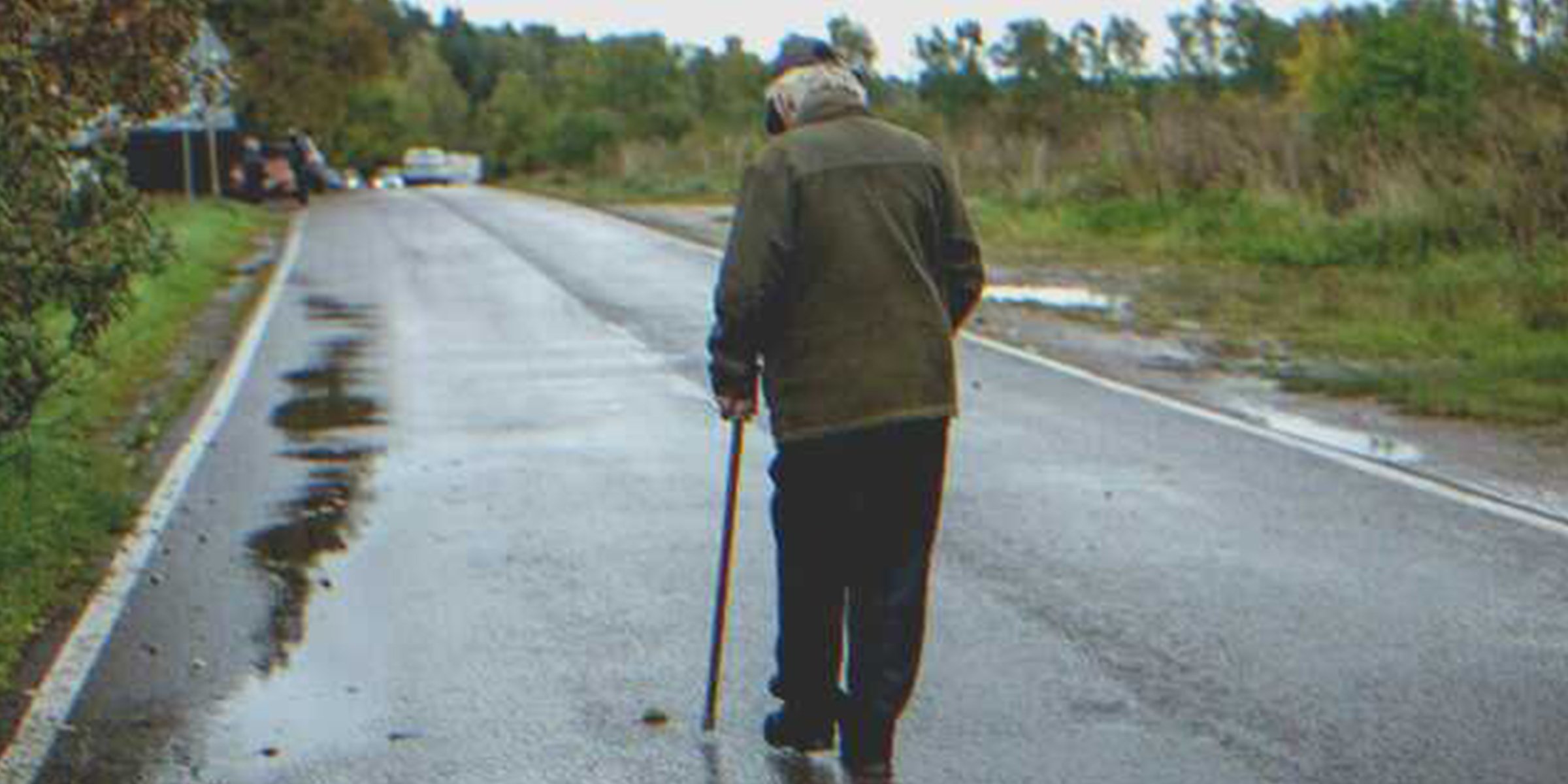 Old Man Walking On Road | Source: Shutterstock