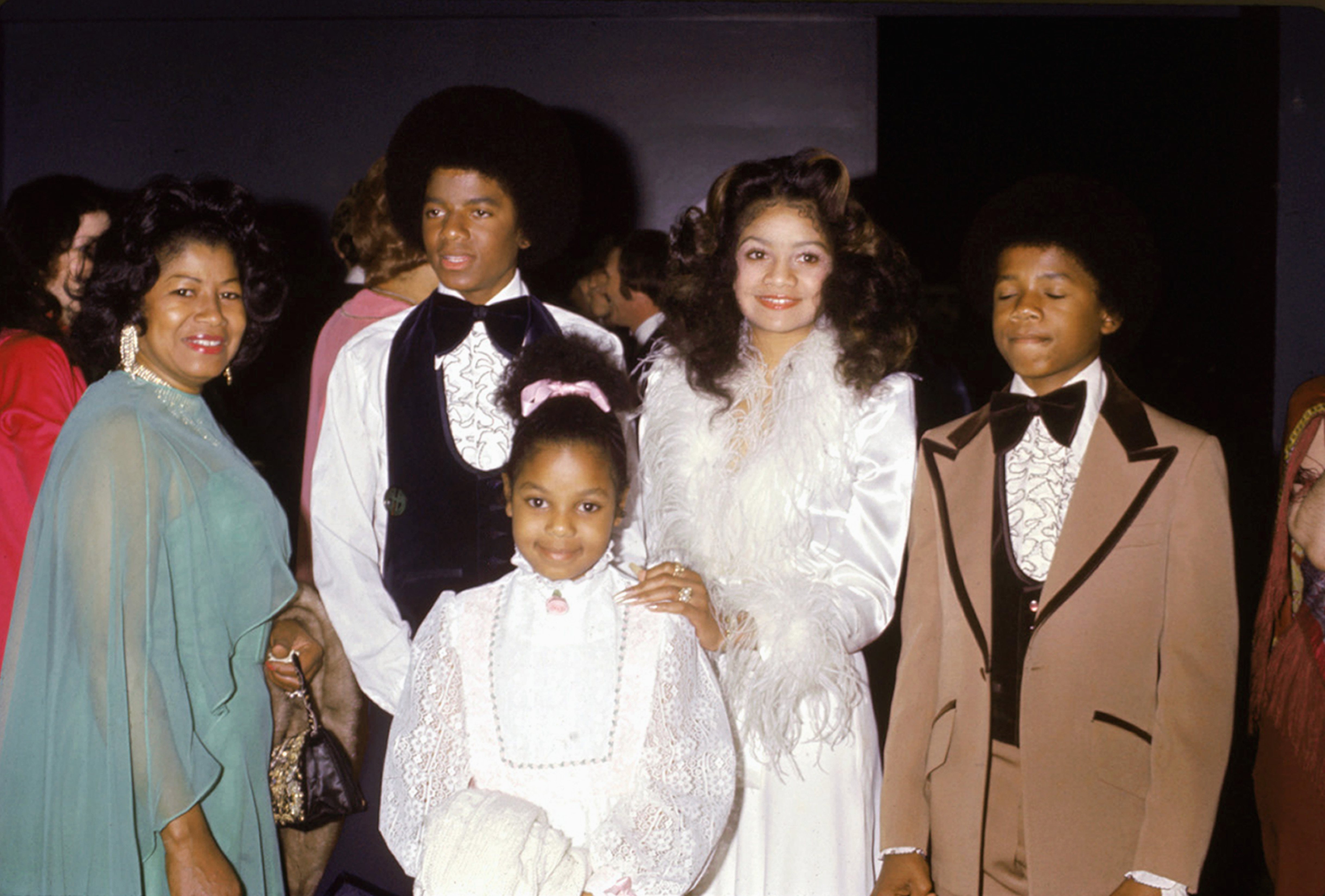 La Toya Jackson poses alongside her siblings Michael, Janet, and Randy Jackson, and their mother Katherine Jackson at Jermaine Jackson's wedding to Hazel Gordy in Hollywood. Dressed in white with feathered details, La Toya stands out with her signature glam flair already forming.