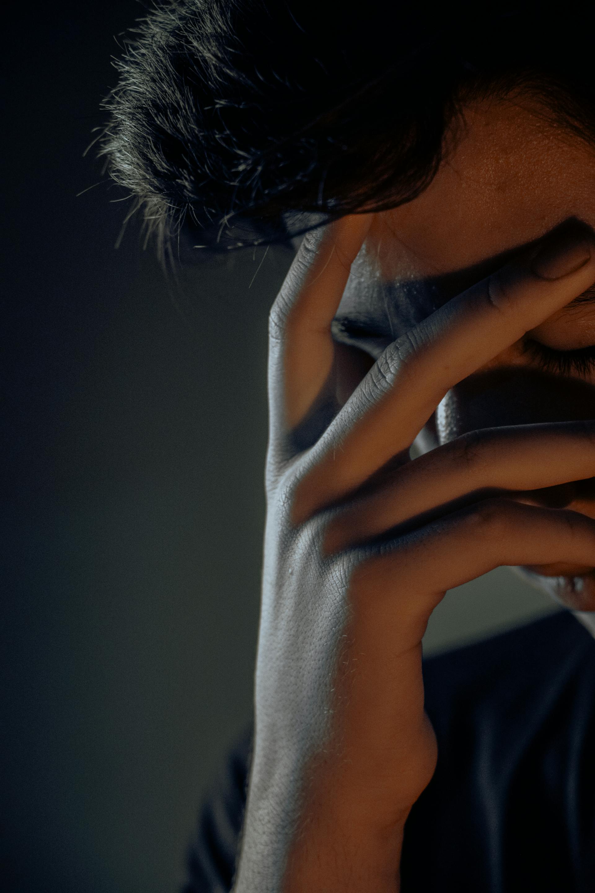 A man covering his face with his hand | Source: Pexels