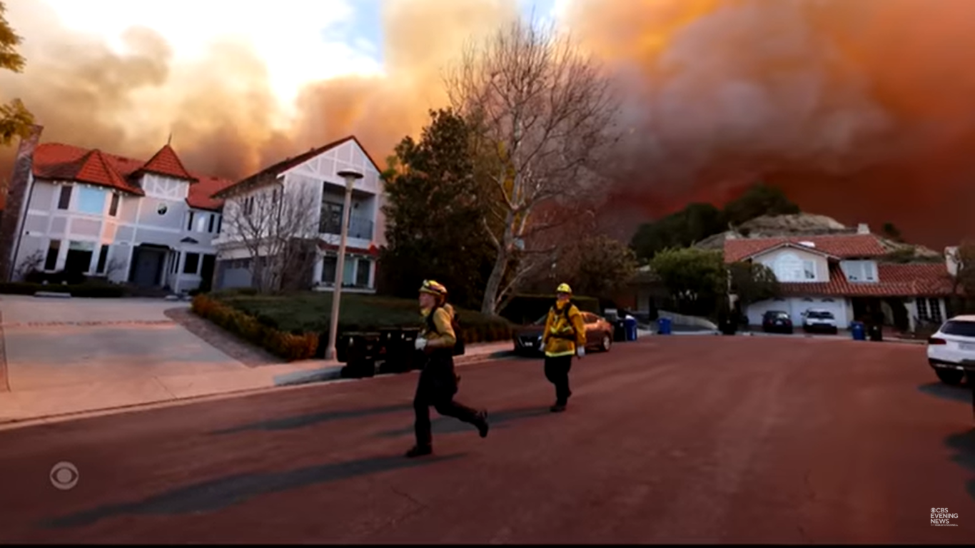 Firefighters pictured at the scene on January 7, 2025, in Los Angeles, California. | Source: YouTube/CBSEveningNews