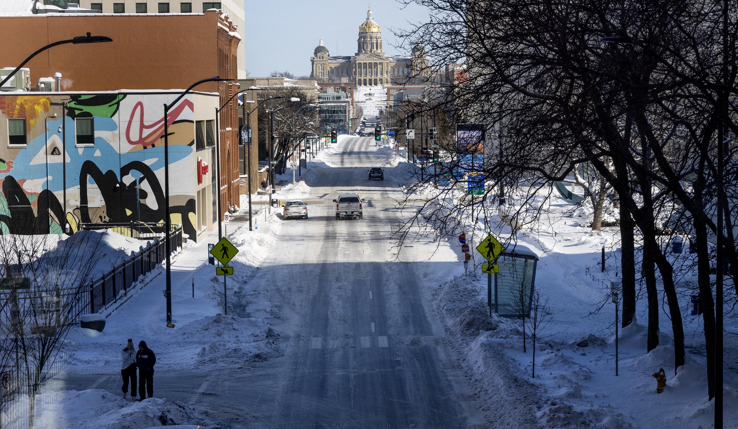 Two pedestrians brave sub-zero temperatures downtown as cold grip Des Moines, Iowa, on January 14, 2024 | Source: Getty Images