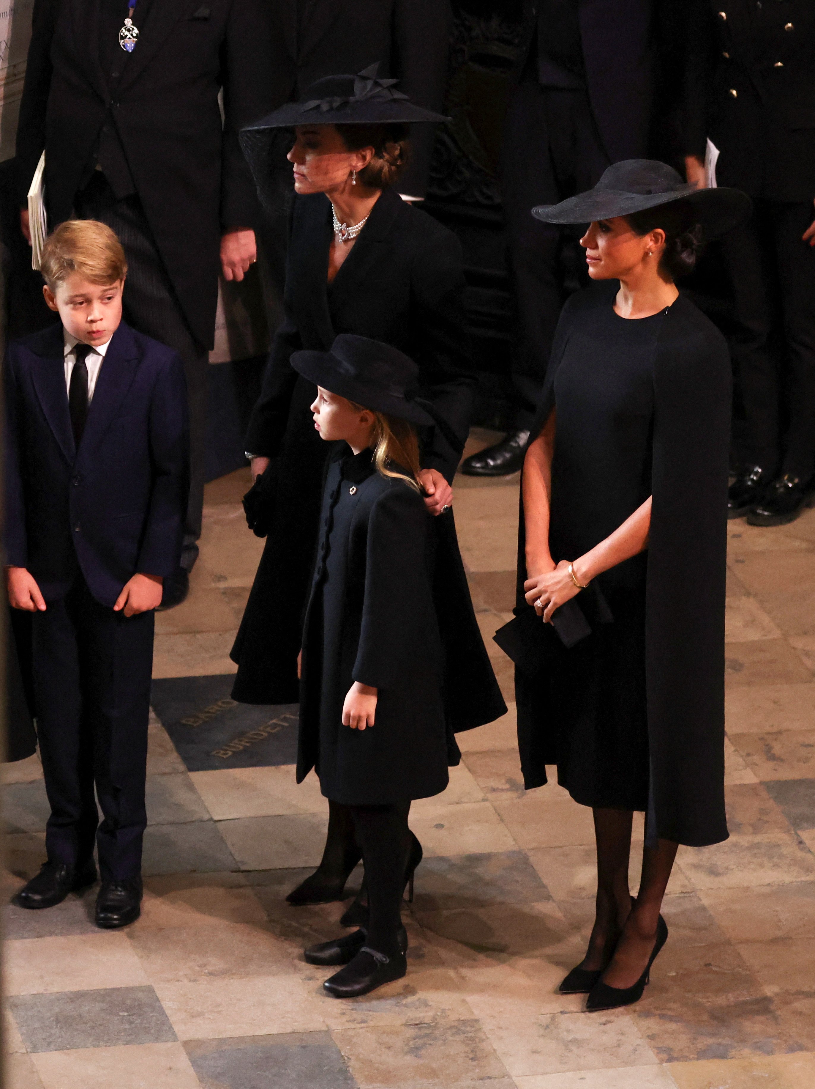 Catherine, Princess of Wales, Meghan, Duchess of Sussex, Prince George, and Princess Charlotte arrive at the State Funeral of Queen Elizabeth II, held at Westminster Abbey on September 19, 2022 in London, England. | Source: Getty Images