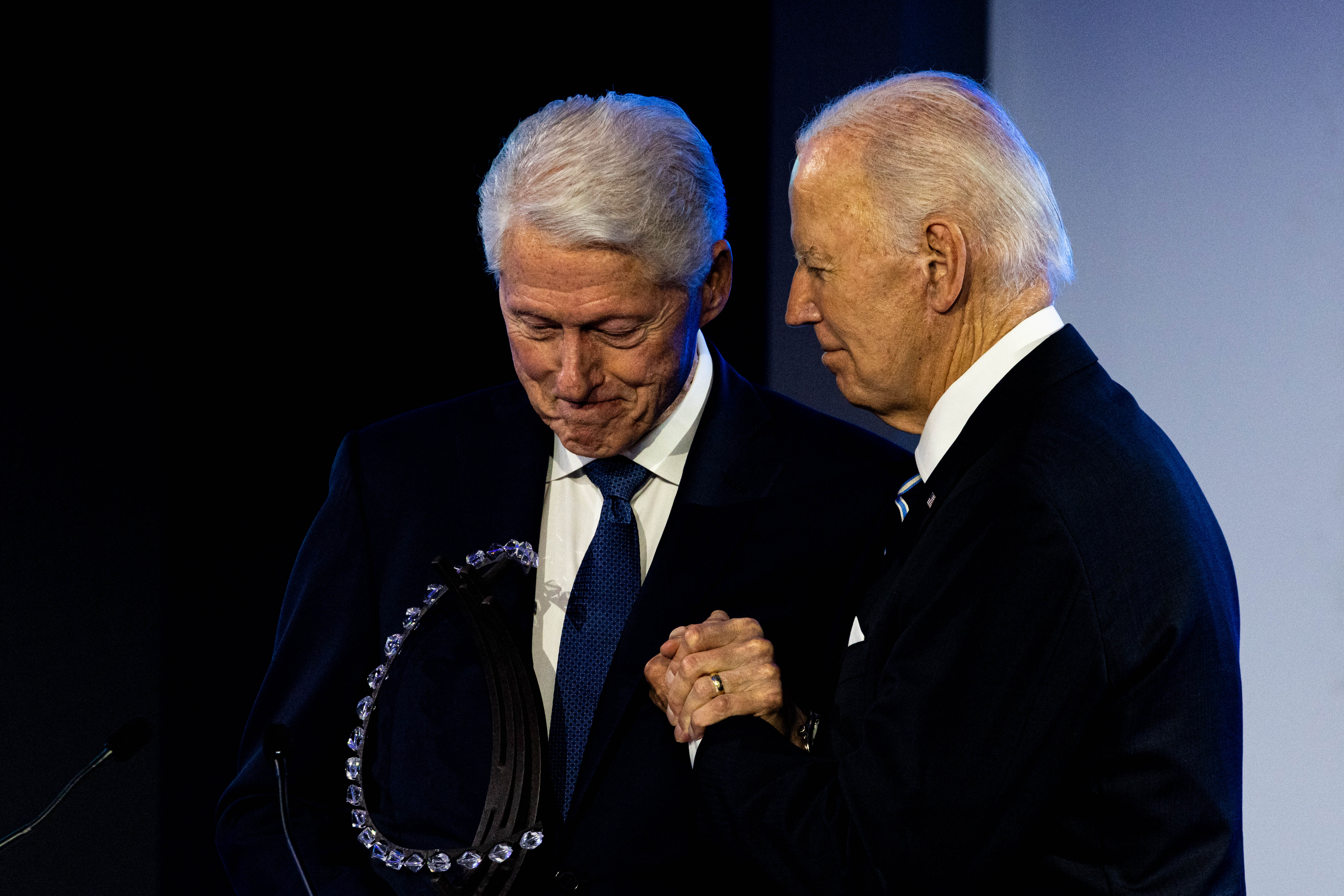 Joe Biden and Bill Clinton photographed shaking hands as Biden accepts the Clinton Global Citizen Award on September 23, 2024, in New York City. | Source: Getty Images