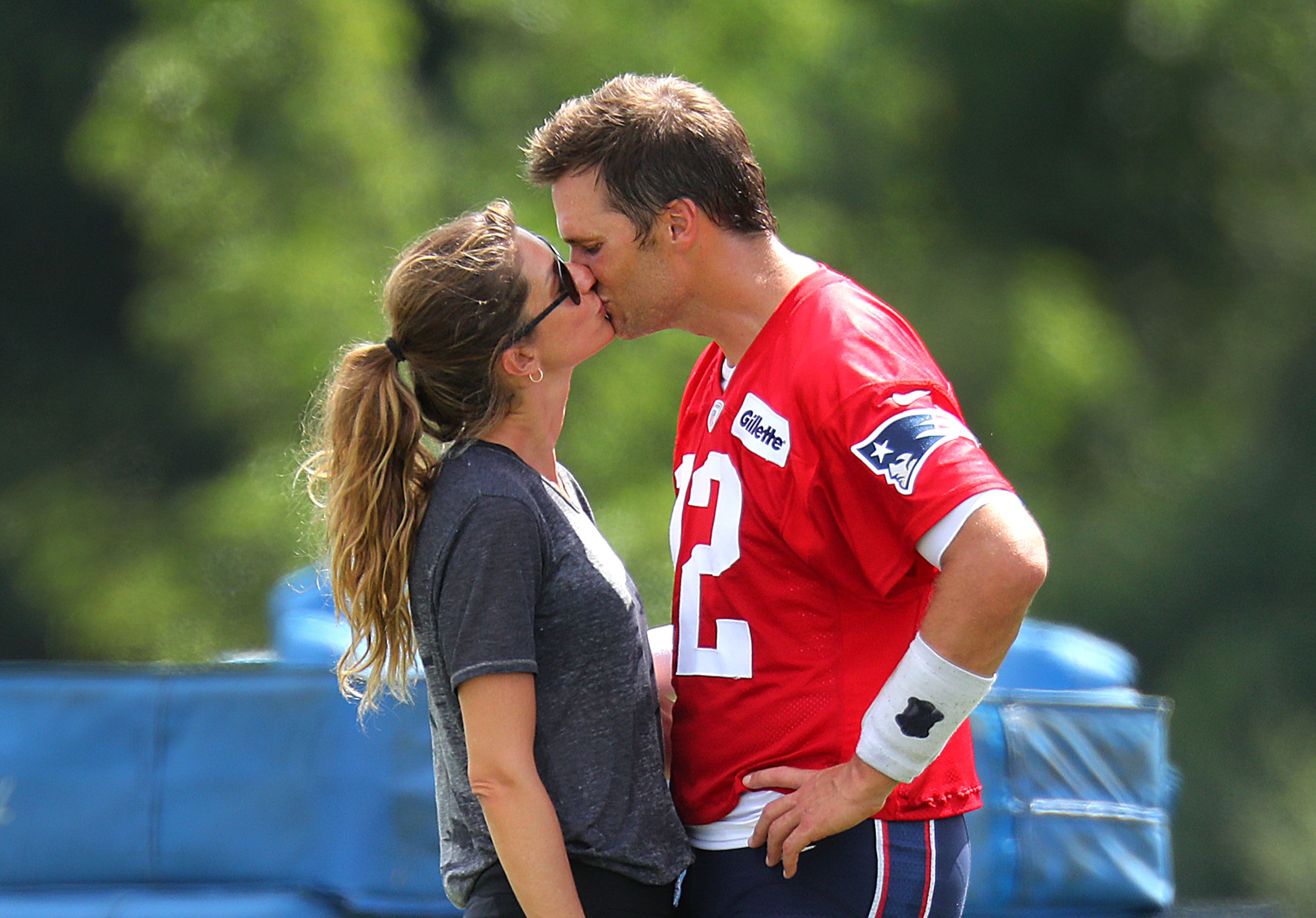 Tom Brady kisses his Gisele Bundchen following Patriots training camp at the Gillette Stadium practice facility in Foxborough, MA on Aug. 3, 2018. | Source: Getty Images