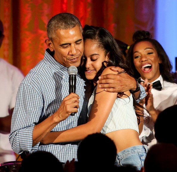 President Barack Obama hugs his daughter Malia at the Fourth of July White House party on July 4, 2016 | Photo: Getty Images