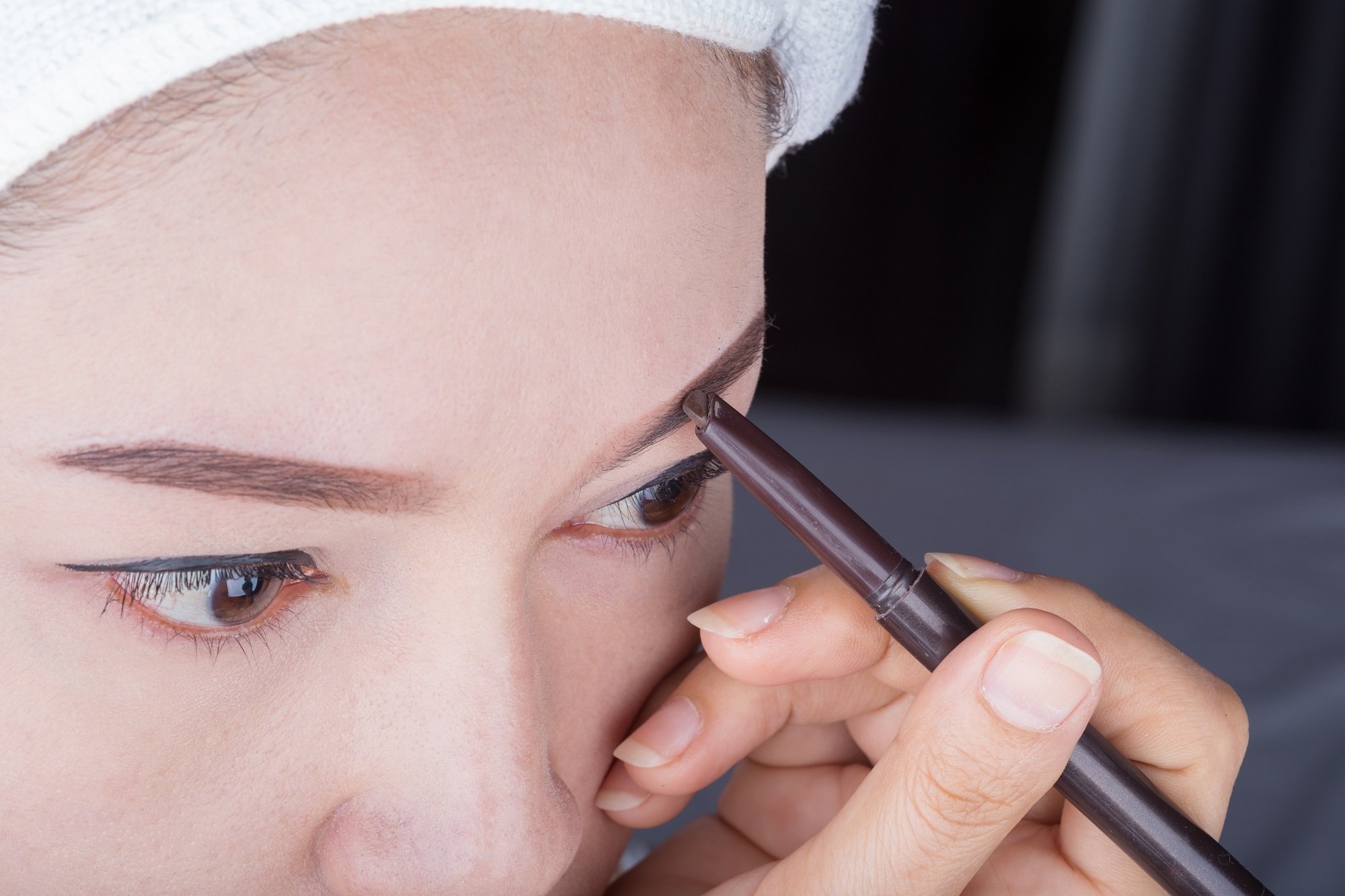 Mujer coreana se aplica maquillaje en las cejas. | Foto: Shutterstock