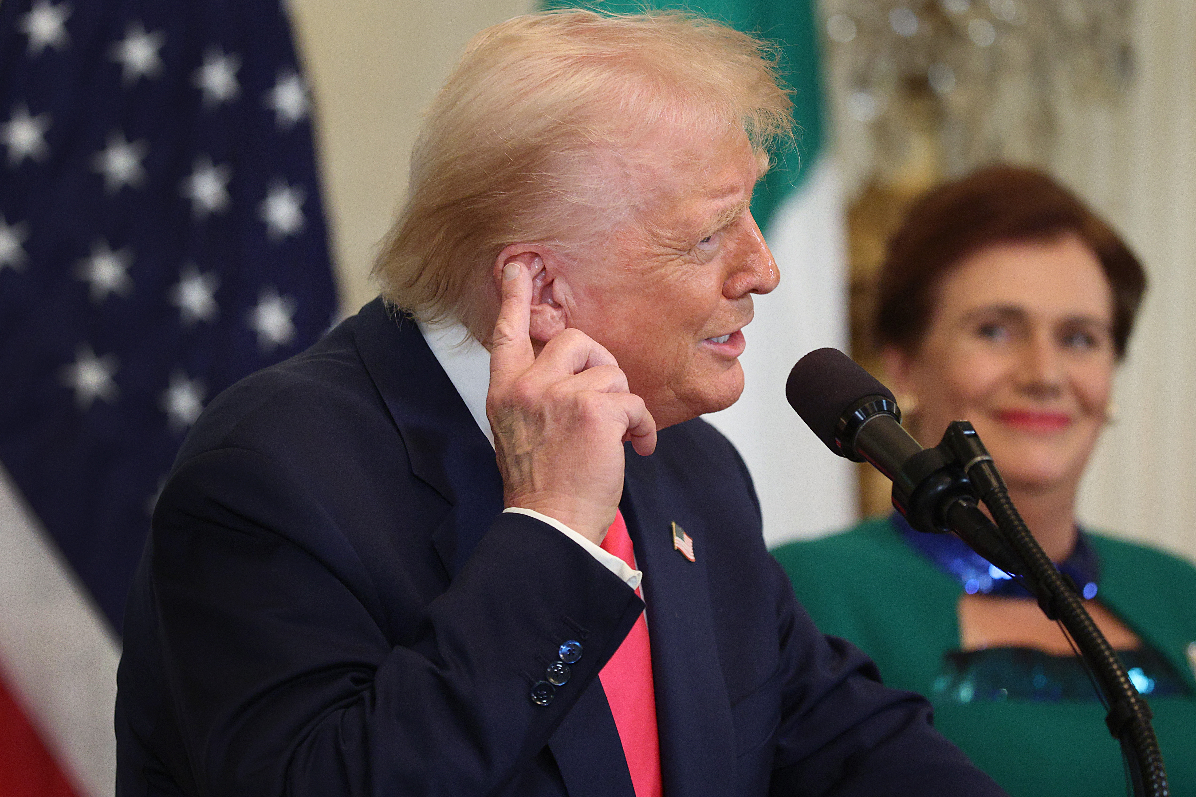 Donald Trump meets with Irish Taoiseach Micheál Martin and his wife Mary O'Shea during a St. Patrick’s Day event in the East Room of the White House on March 12, 2025, in Washington, D.C. | Source: Getty Images