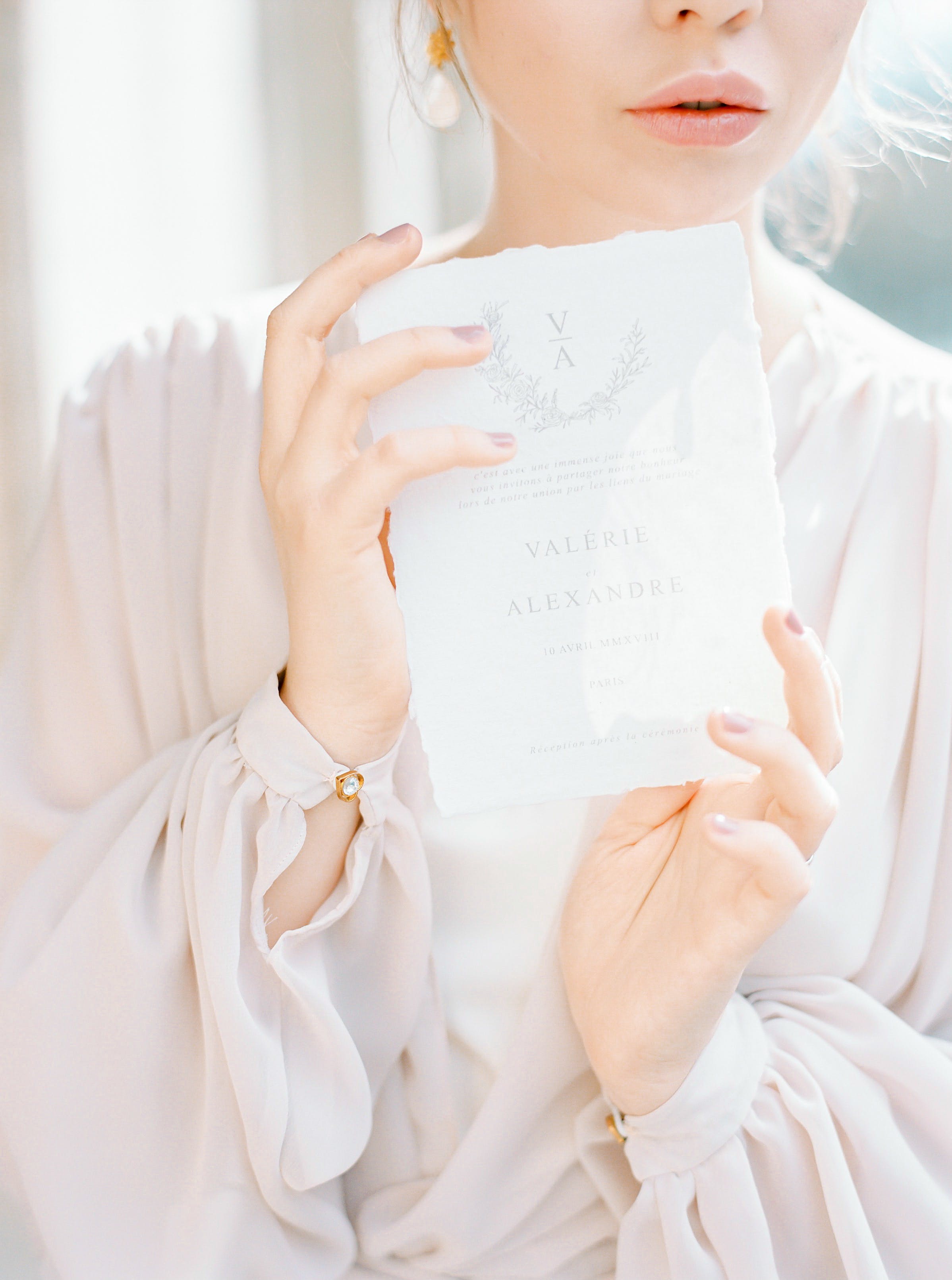 A woman holding a wedding invitation | Source: Pexels