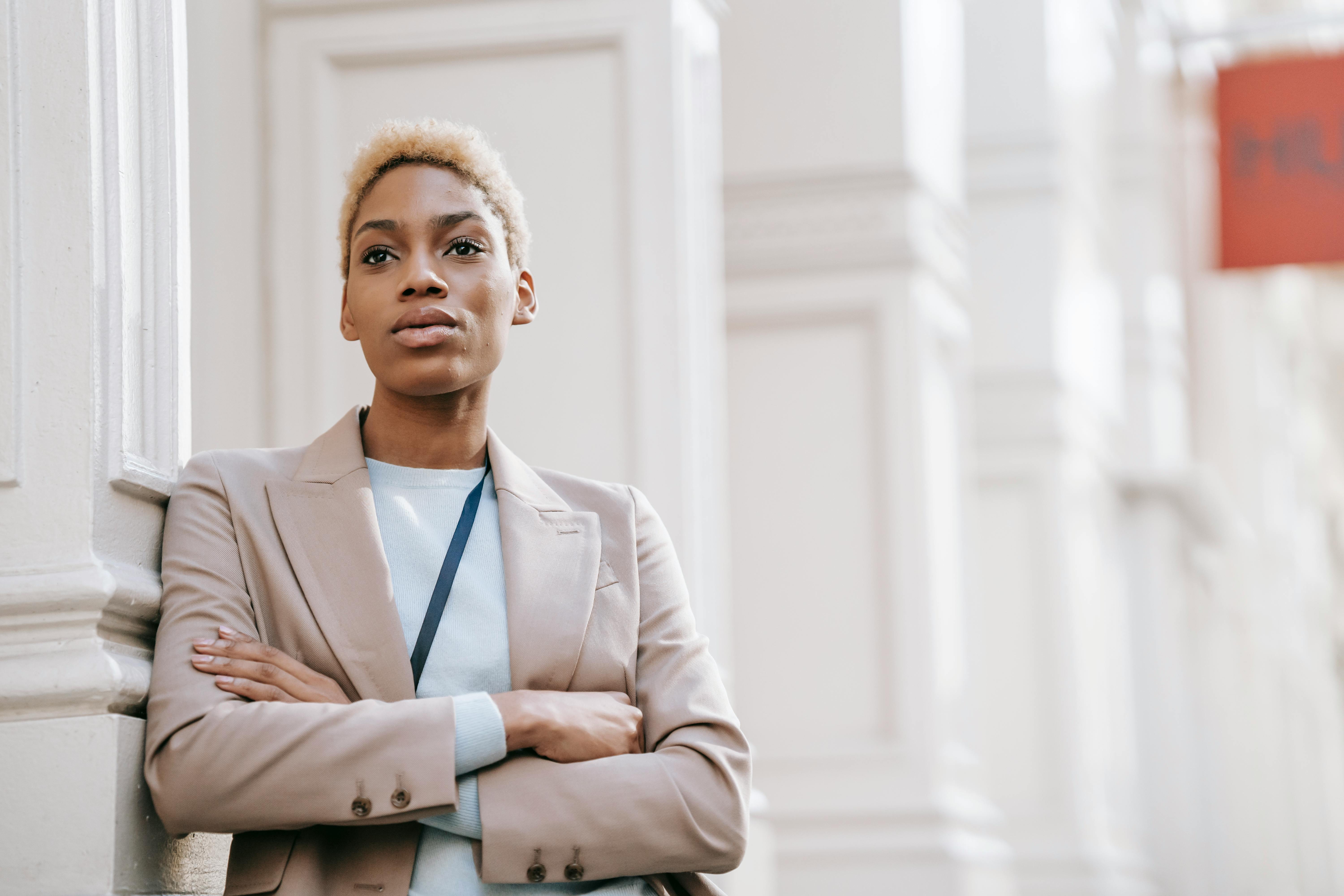 A neutral-looking woman with her arms folded | Source: Pexels