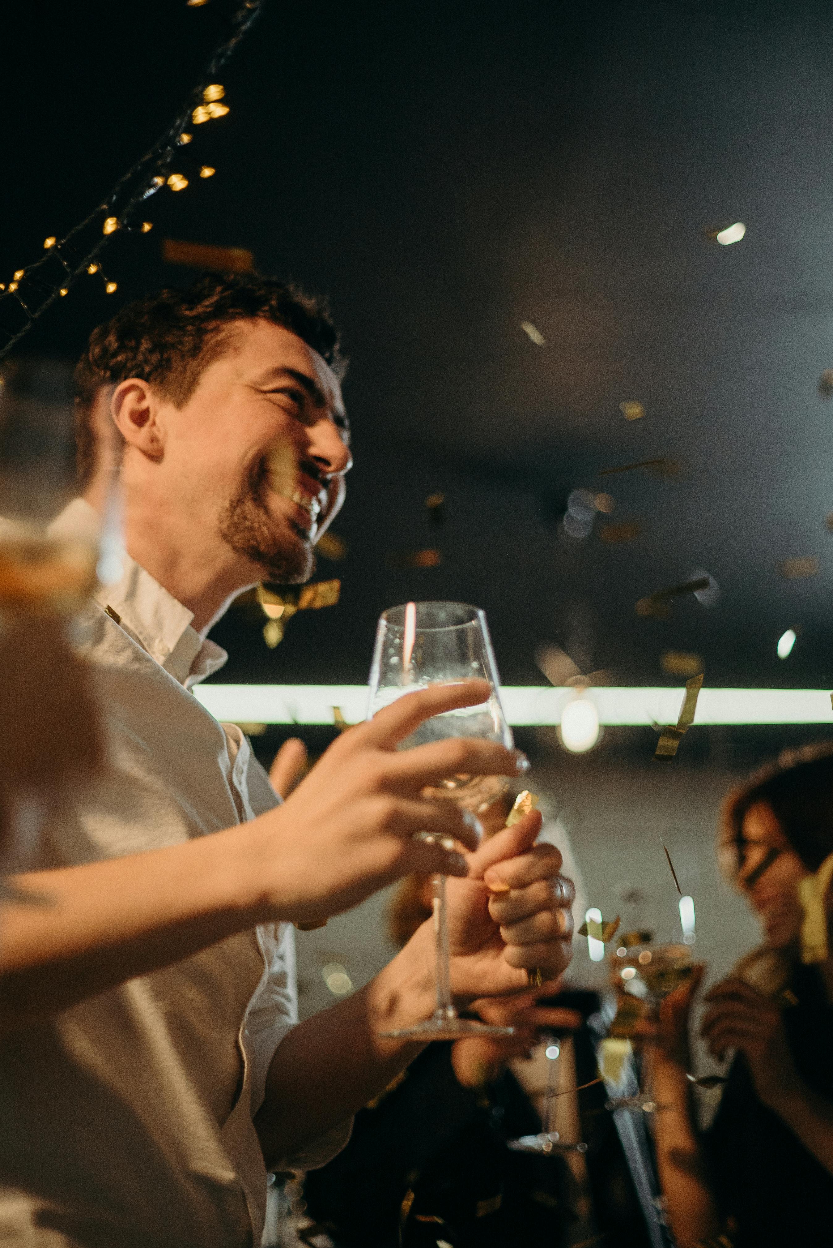 A smiling man at a party | Source: Pexels