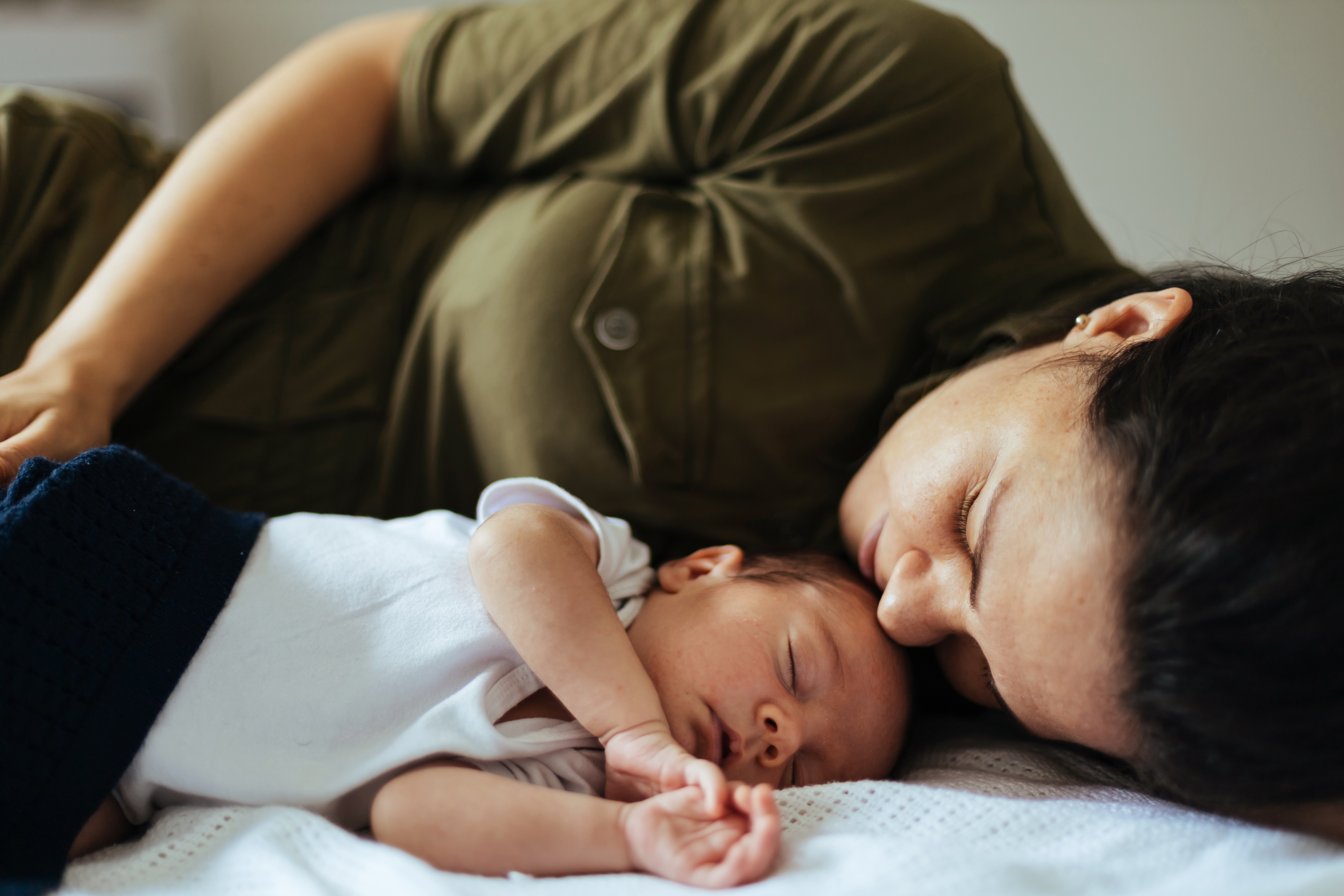 A woman sleeping with a baby | Source: Shutterstock