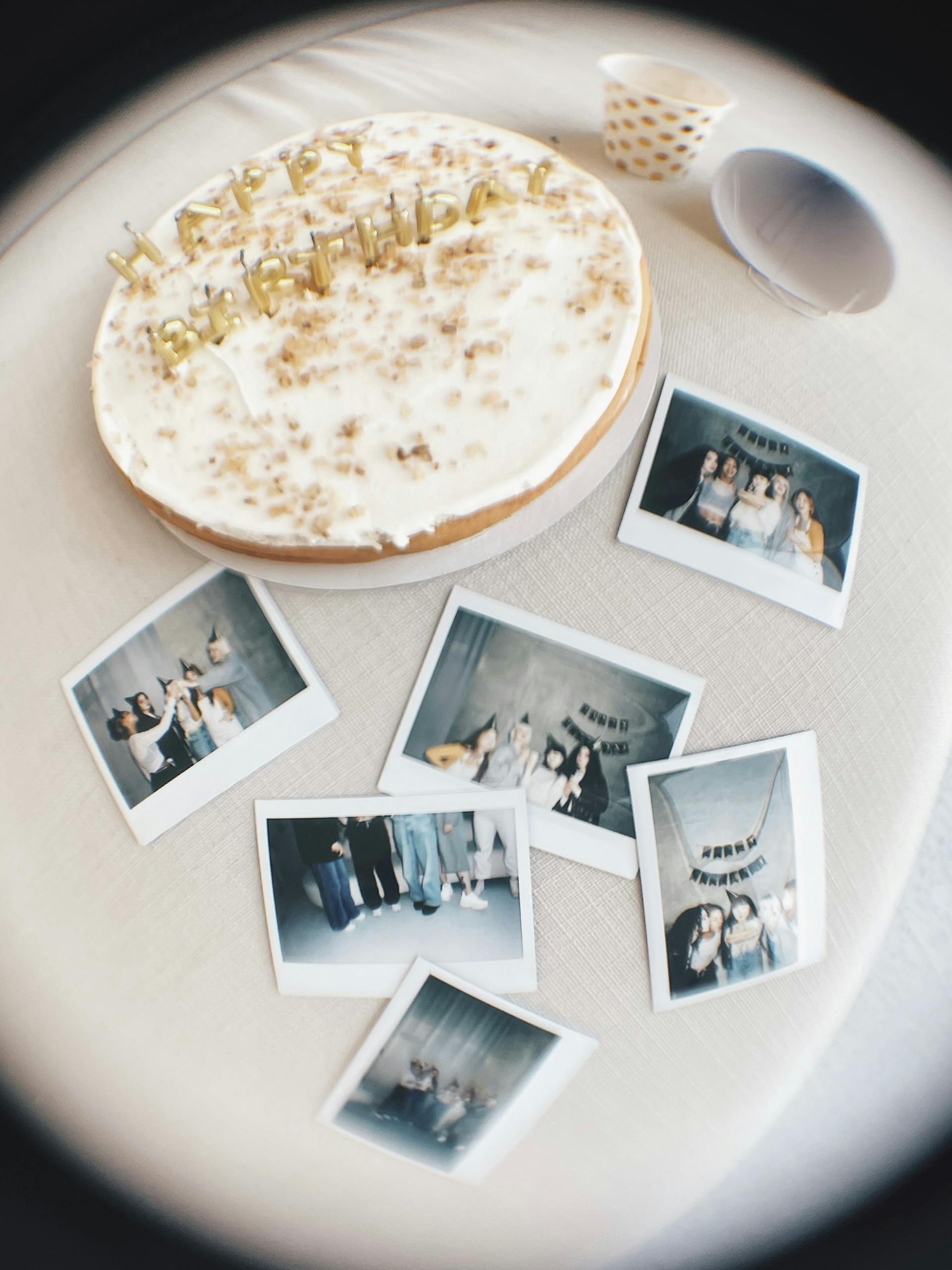 Photographs lying beside a birthday cake | Source: Pexels