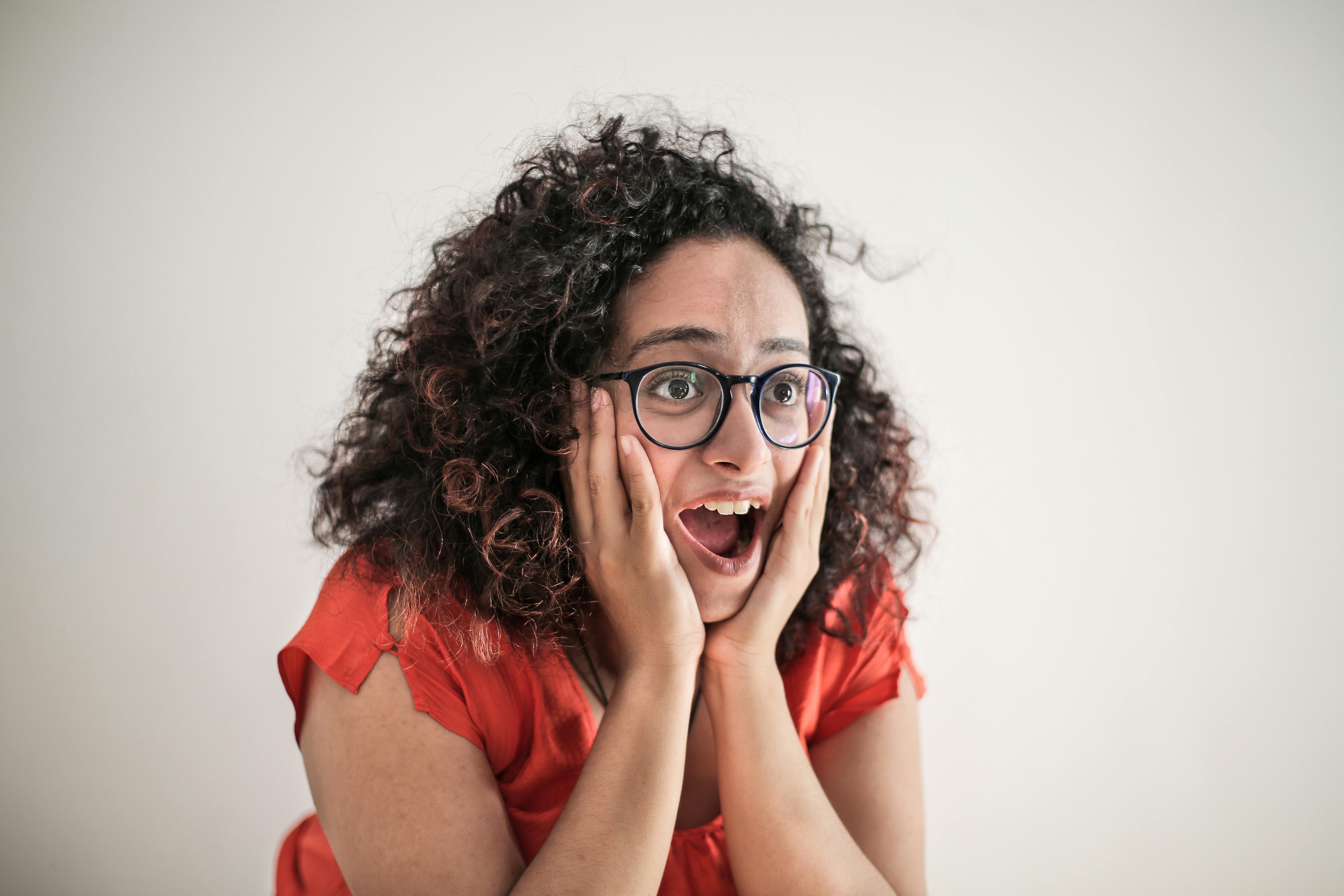 A shocked woman with her hands on her face | Source: Pexels