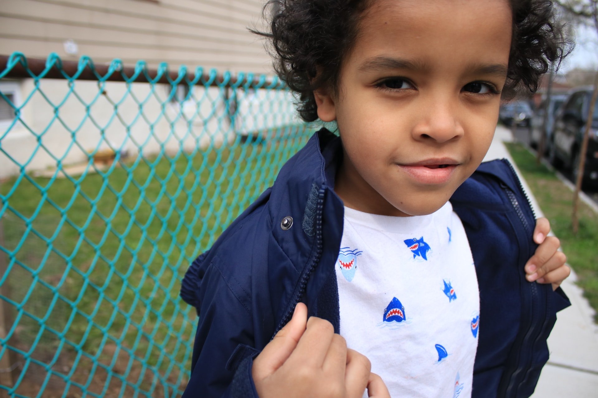 Close-up of child wearing blue jacket | Source: Unsplash