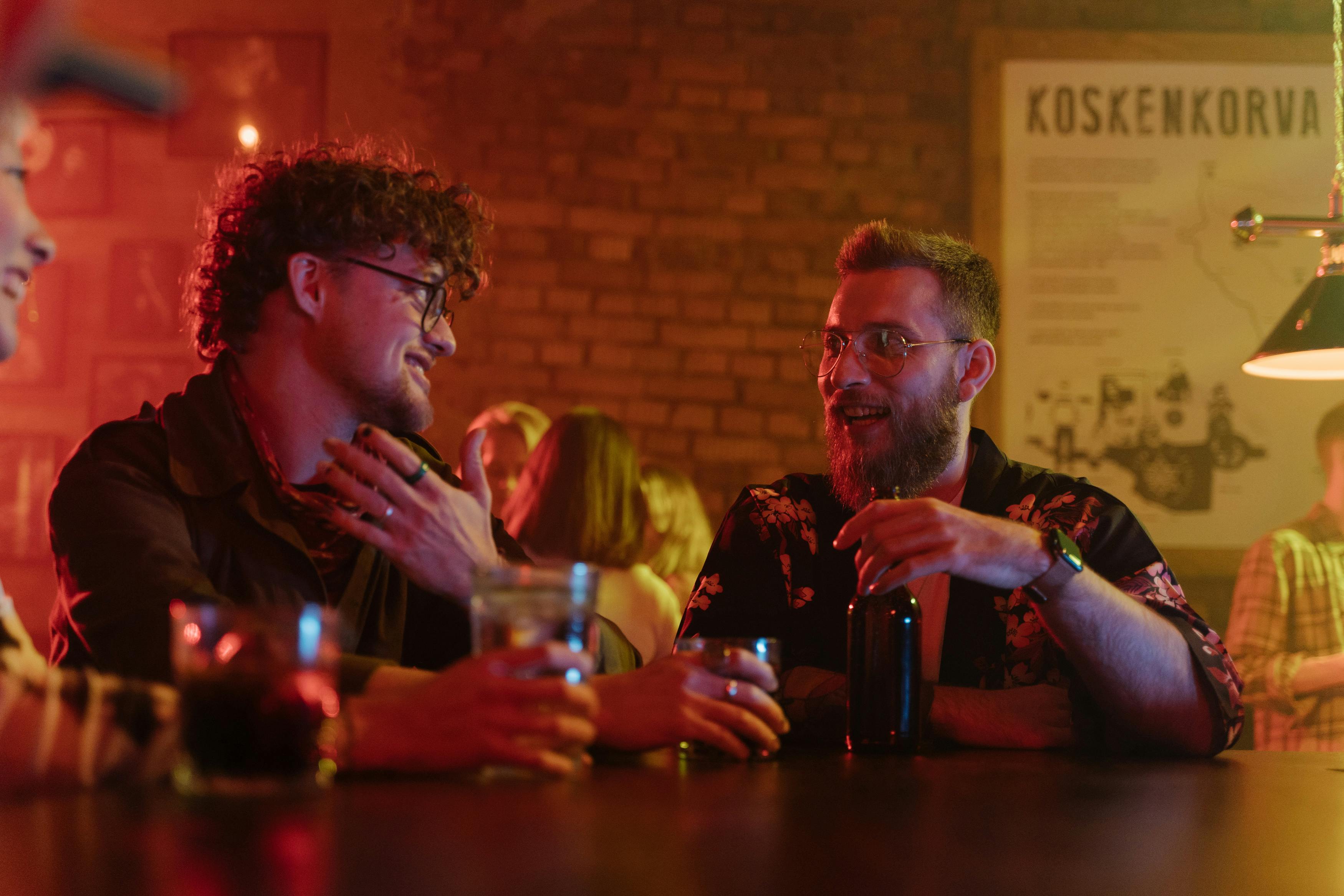 Two men sharing a laugh at a bar | Source: Pexels