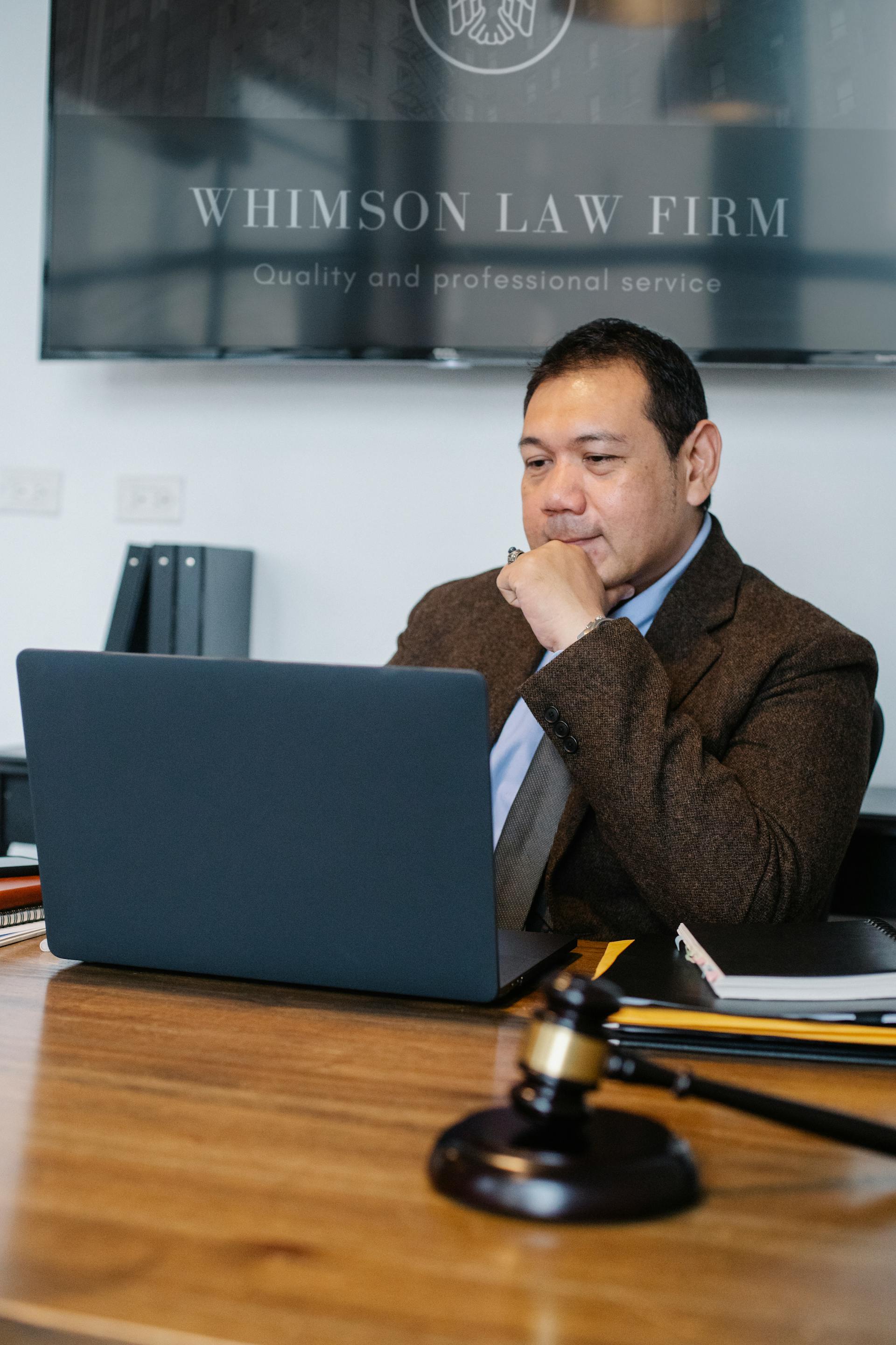 A male lawyer using a laptop in his office | Source: Pexels