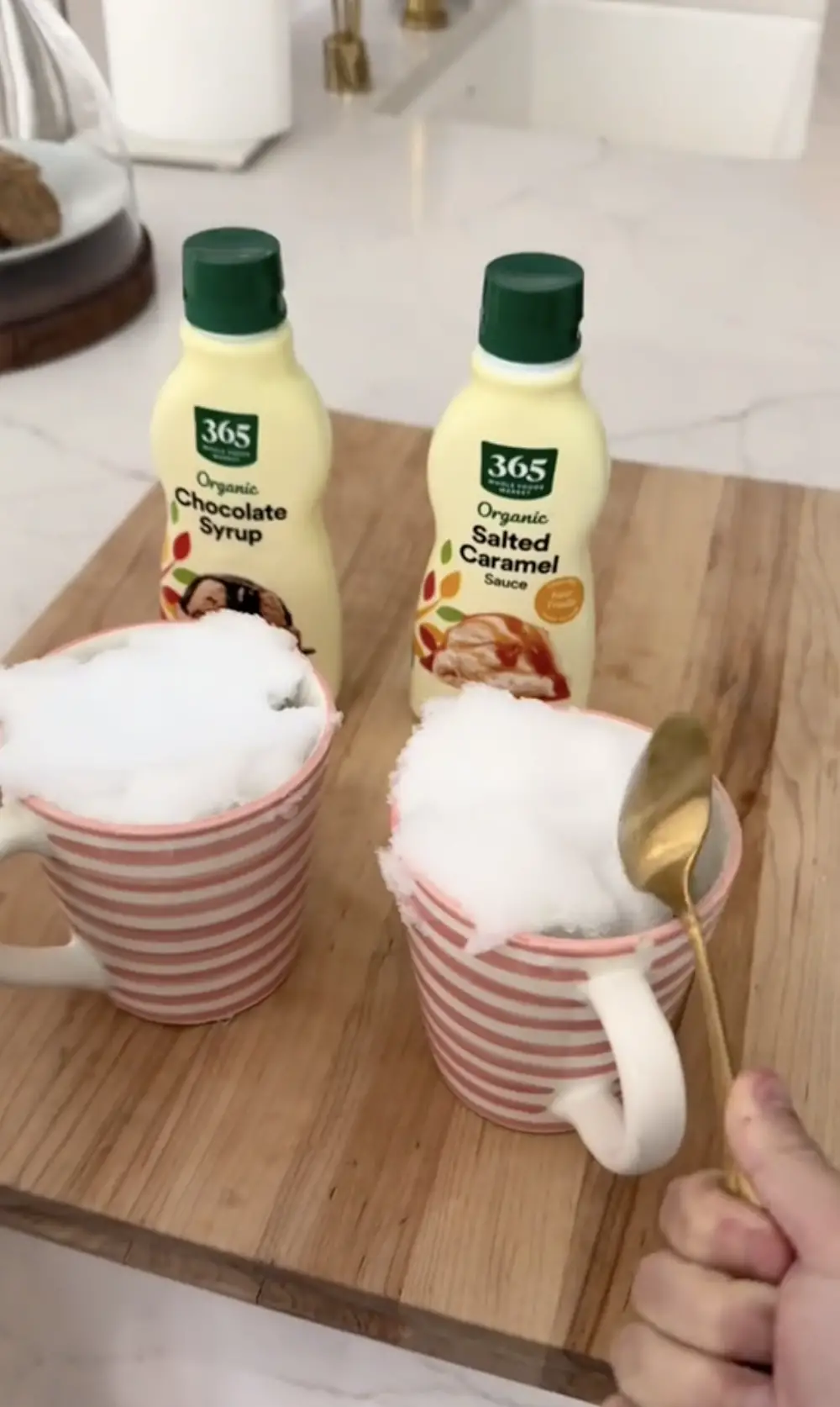 Reese Witherspoon preparing her winter dessert in two mugs, as seen in a video dated January 19, 2024 | Source: tiktok.com/@reesewitherspoon