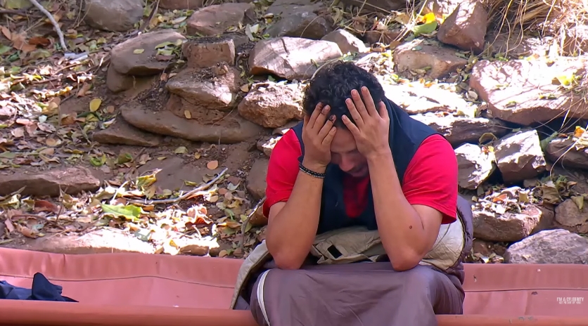 Adam Thomas sits with his head in his hands during a tense moment in camp, captured in a video dated 20 April 2026. | Source: YouTube/I'm A Celebrity... Get Me Out Of Here!