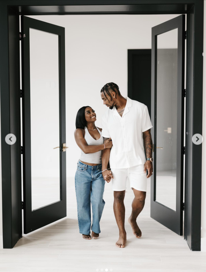 Jonathan Owens and Simone Biles walk barefoot through sleek black double doors, hand in hand, from a post dated September 19, 2025 | Source: Instagram/simonebiles