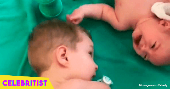 Video of little boy born without hands helping his newborn brother goes viral