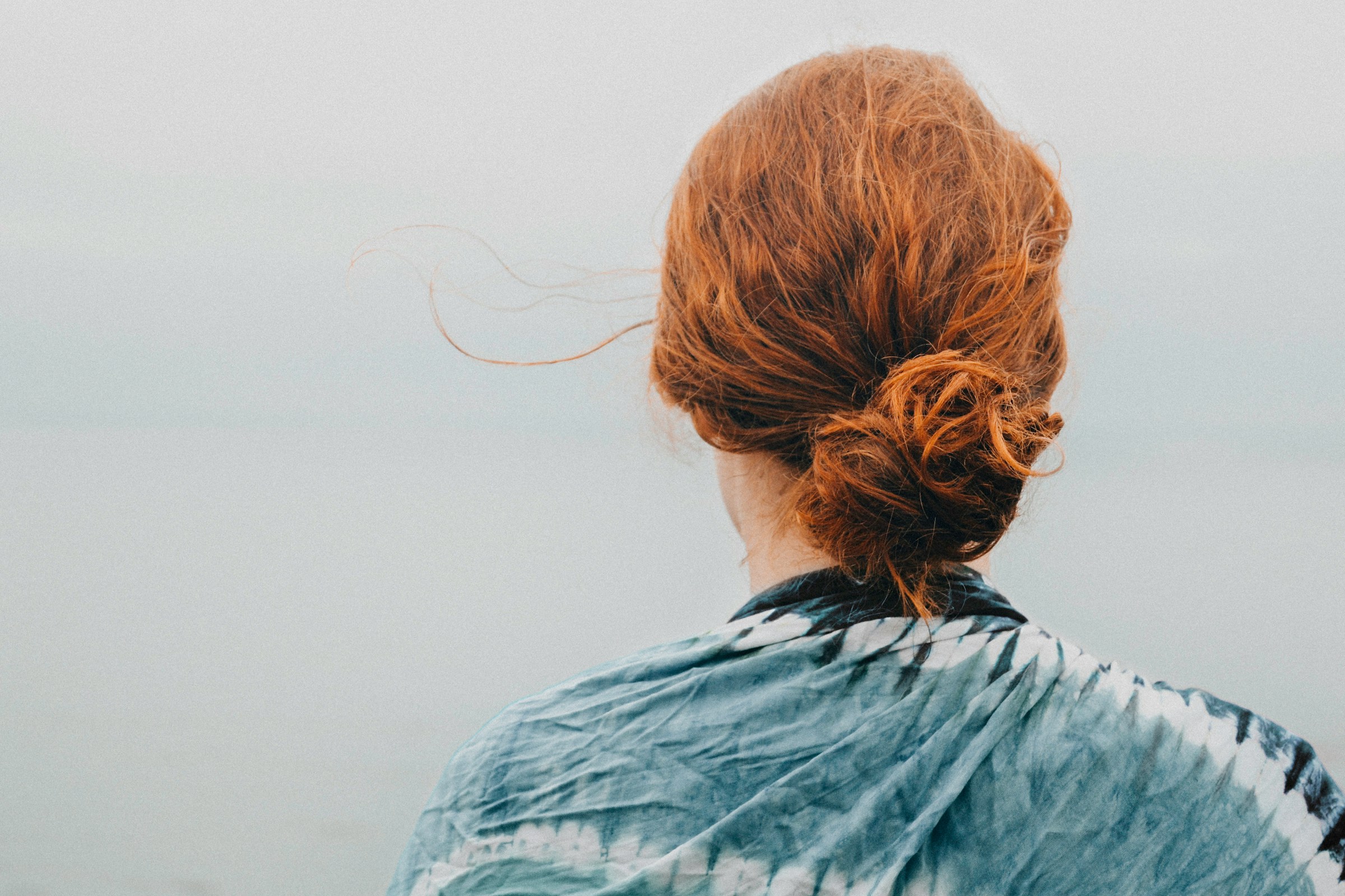 A woman showing off red hair | Source: Unsplash