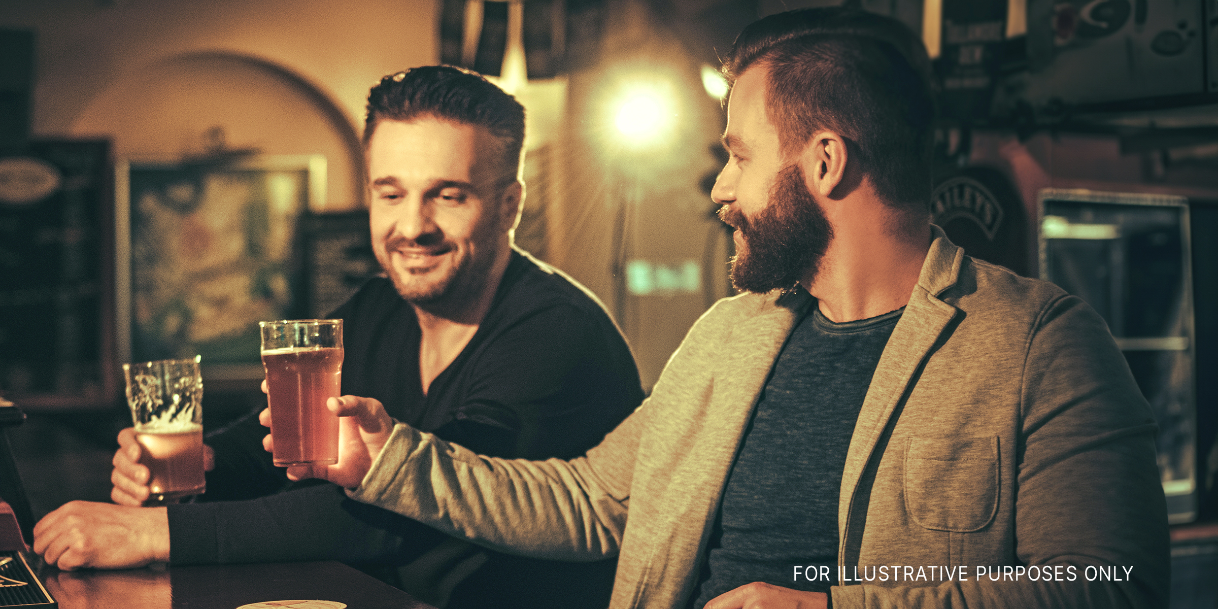 Two men having drinks in a pub | Source: Shutterstock