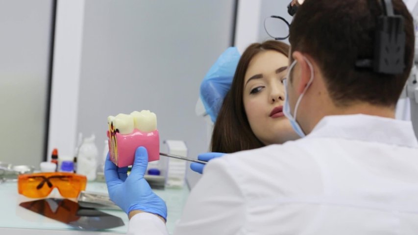 Dentist attending to a dental patient | Photo: Shutterstock