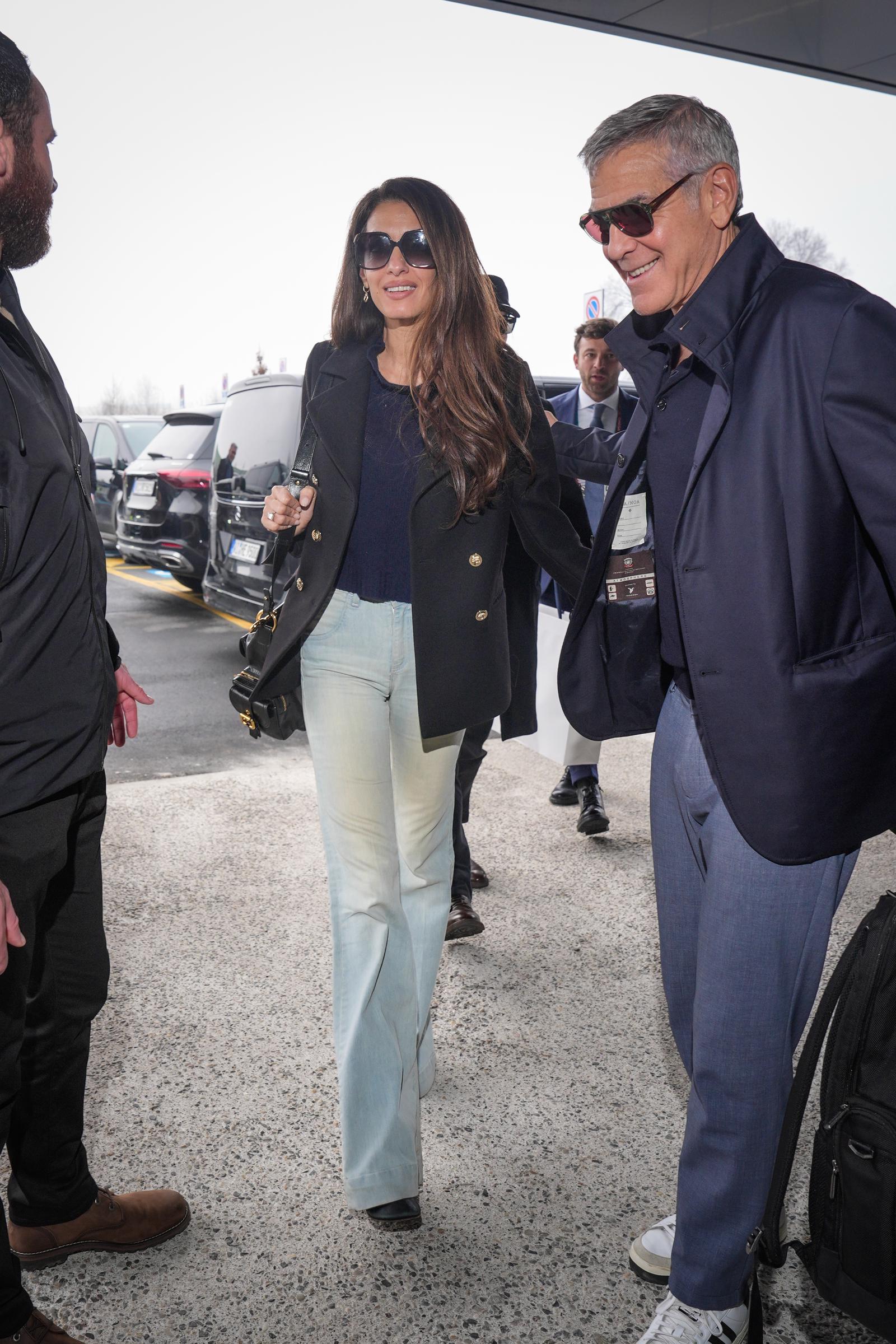 George Clooney and Amal Clooney arrive at the airport on February 8, 2026, in Milan, Italy | Source: Getty Images