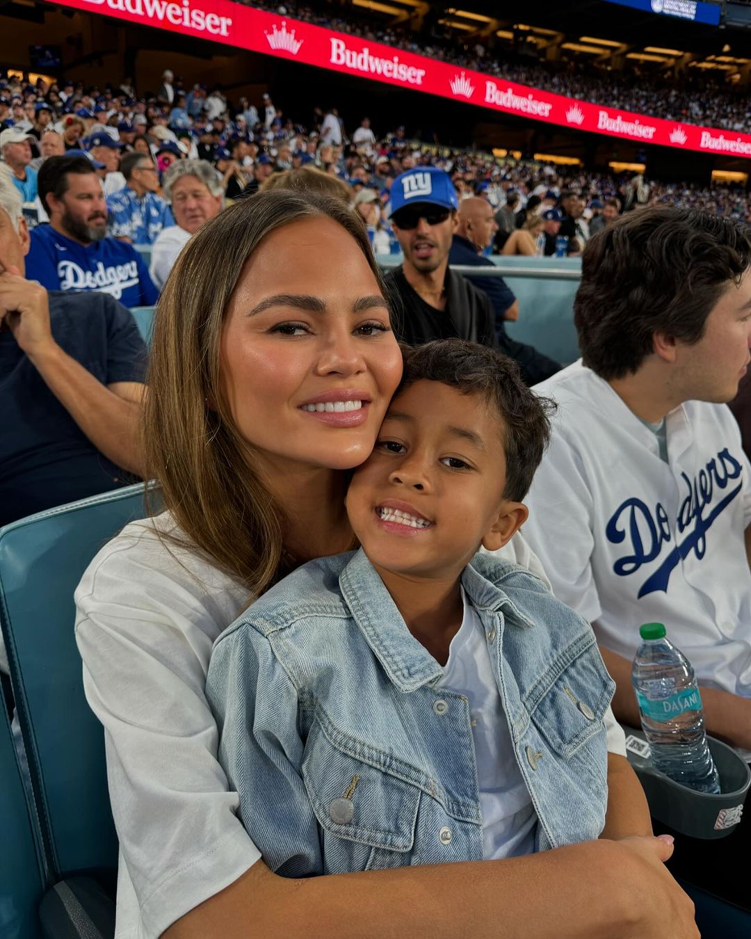 Chrissy Teigen and Miles at a game between the Los Angeles Dodgers and New York Mets, from a post dated October 22, 2024 | Source: Instagram/johnlegend/