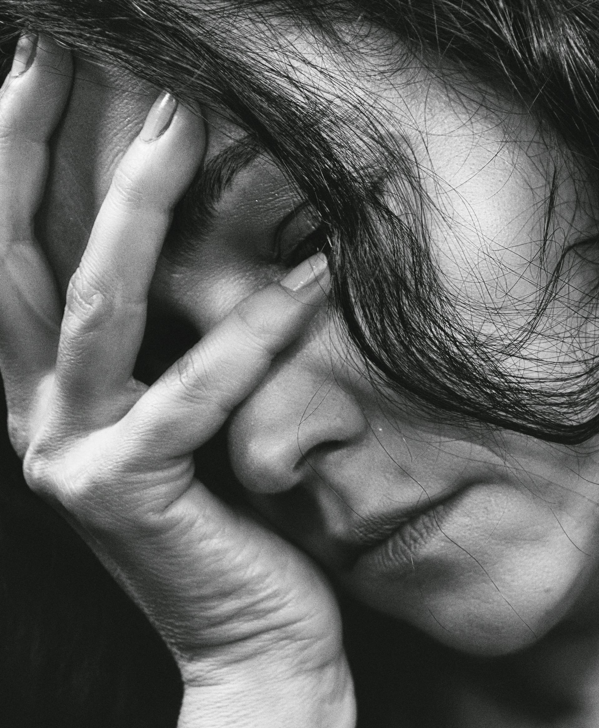 A woman with her head in one hand | Source: Pexels