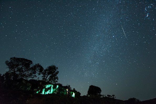A meteor streaks across the night sky during the Geminid Meteor Shower over Harishchandra Fort on December 15, 2018 in Ahmednagar, India. | Photo: Getty Images