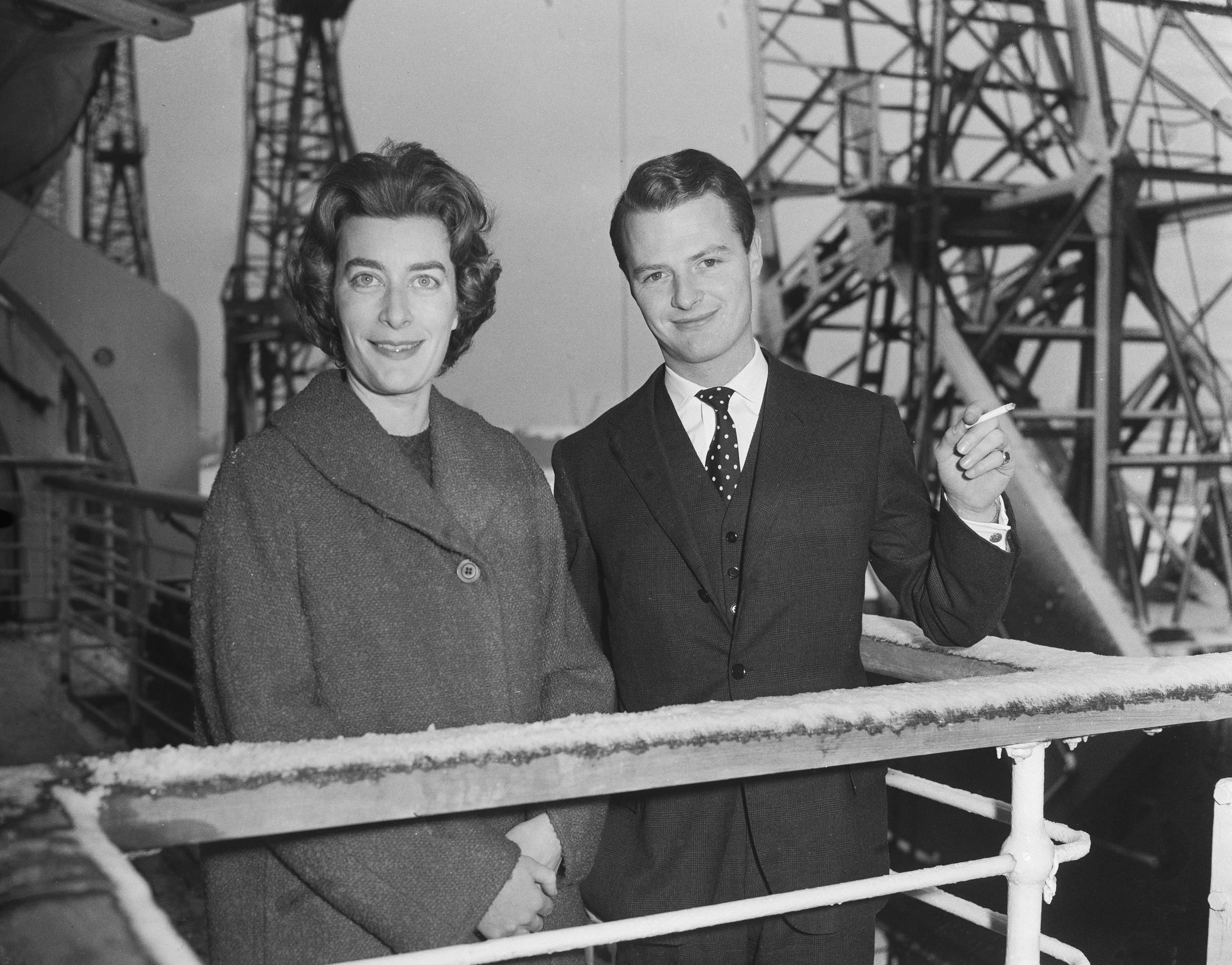 Taken on 14 January 1960 aboard the RMS Queen Elizabeth at Southampton, Lady Pamela Hicks stands beside David Hicks as the newlyweds prepare to depart for their honeymoon, marking the beginning of their journey to New York and the West Indies together.