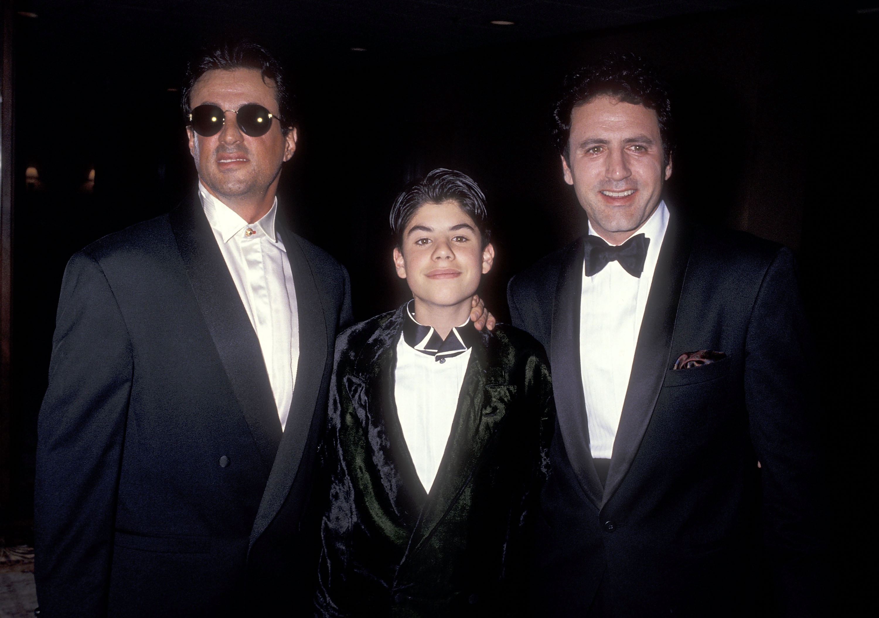 The boy, his father, and his brother at the Fifth Annual Fashion Show & Dinner Benefit Salute to Gianni Versace sponsored by the California Fashion Industry Friends of AIDS Project Los Angeles in Century City, California, on February 13, 1991 | Source: Getty Images