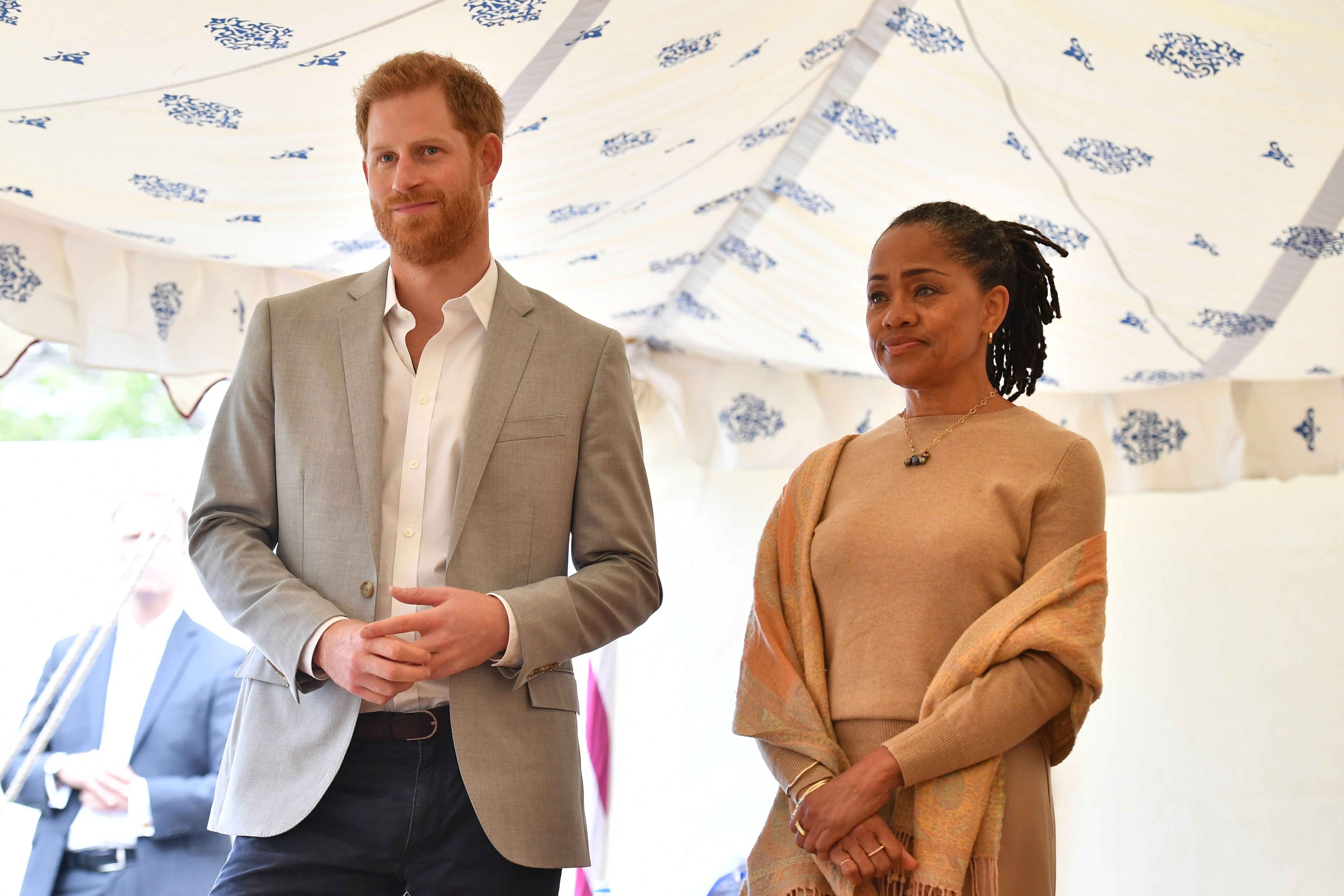 Prince Harry and Doria Ragland listen to Meghan, speaking at an event to mark the launch of a cookbook with recipes from a group of women affected by the Grenfell Tower fire at Kensington Palace on September 20, 2018 in London, England | Photo: Getty Images