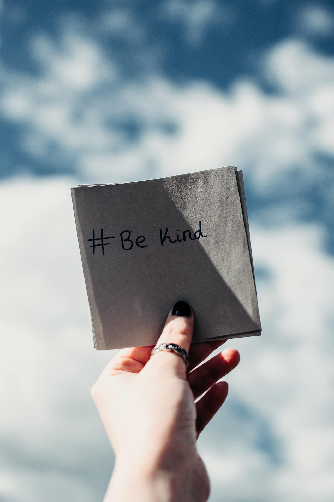 A woman holding a piece of note with a thought-provoking message | Source: Pexels