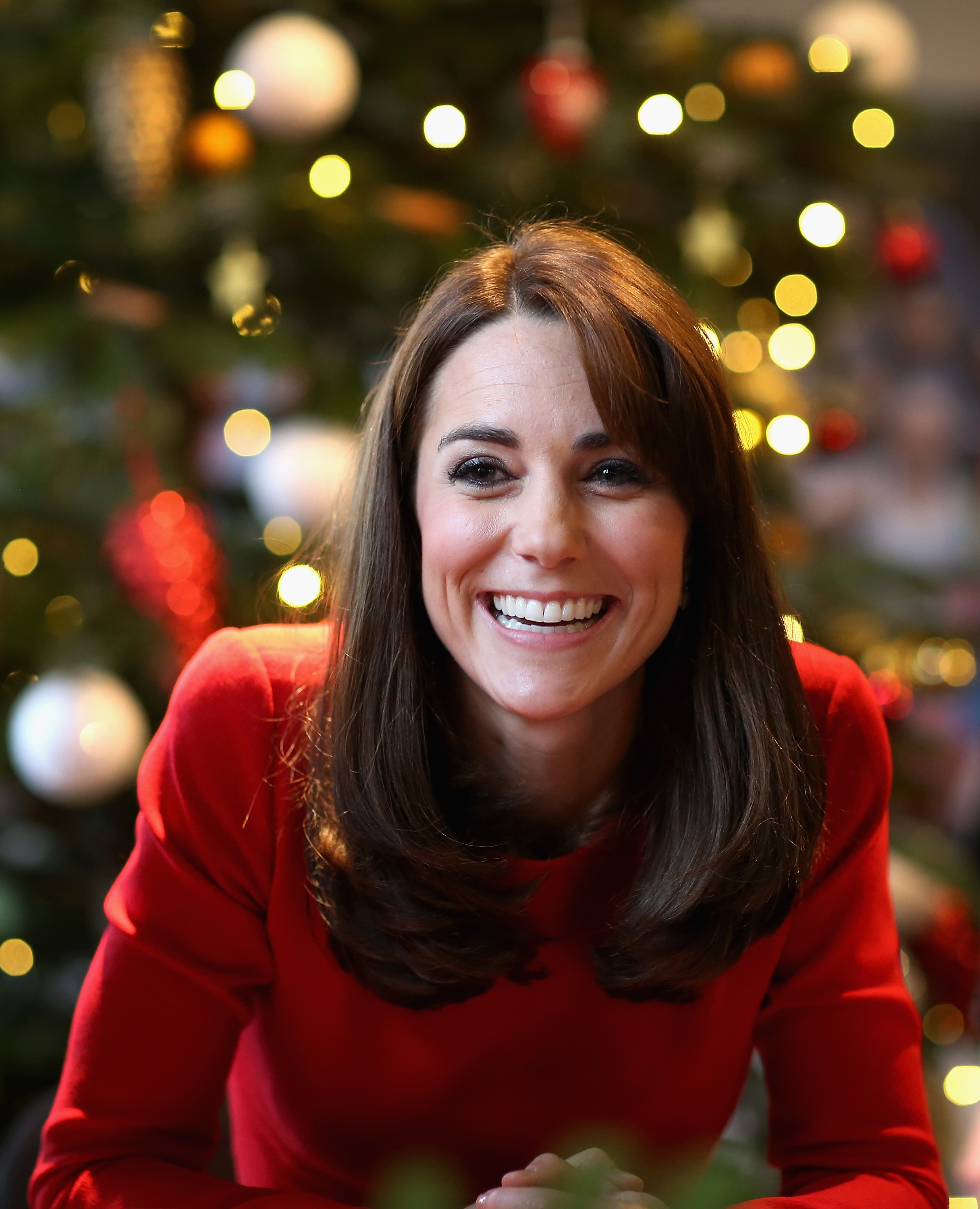 Catherine, Duchess of Cambridge, attends the Anna Freud Centre Family School Christmas Party. She appeared smiling and wore her hair in a long style with soft curls at the ends, creating a subtle bob-like effect.