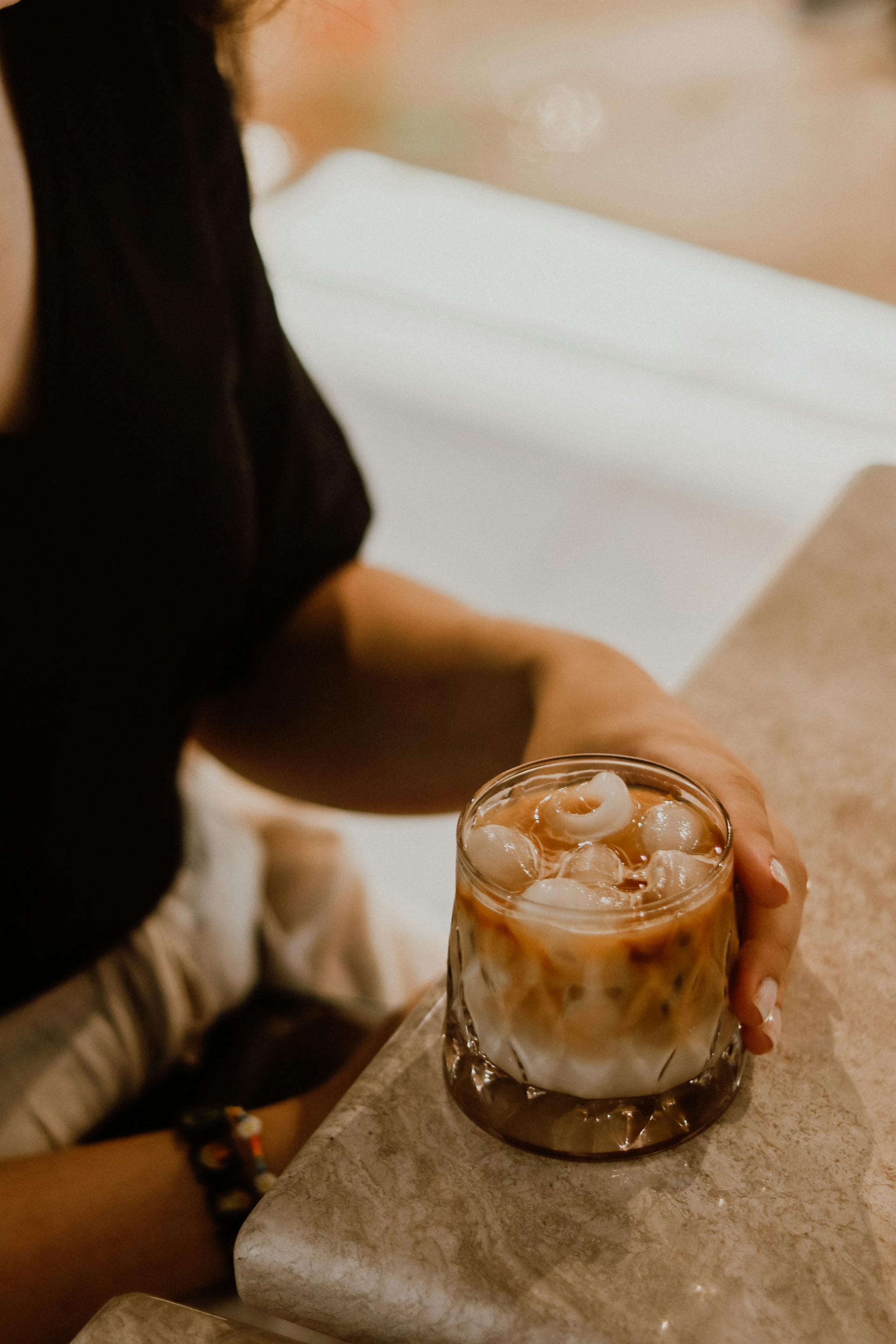 Person having an iced beverage at a restaurant | Source: Pexels