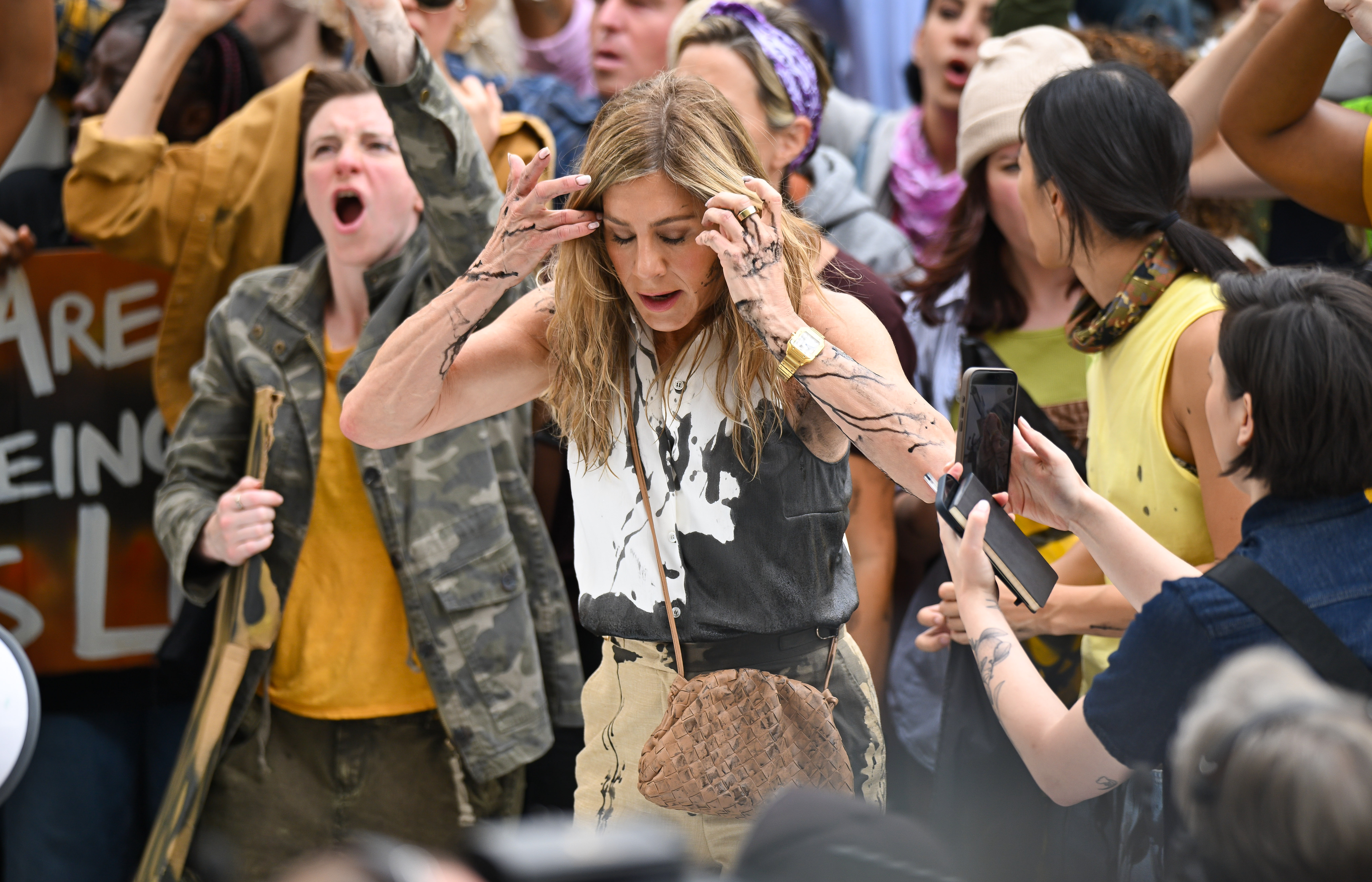 Jennifer Aniston reacts as black oil splashes on her in the Flatiron District of New York City on July 28, 2024 | Source: Getty Images