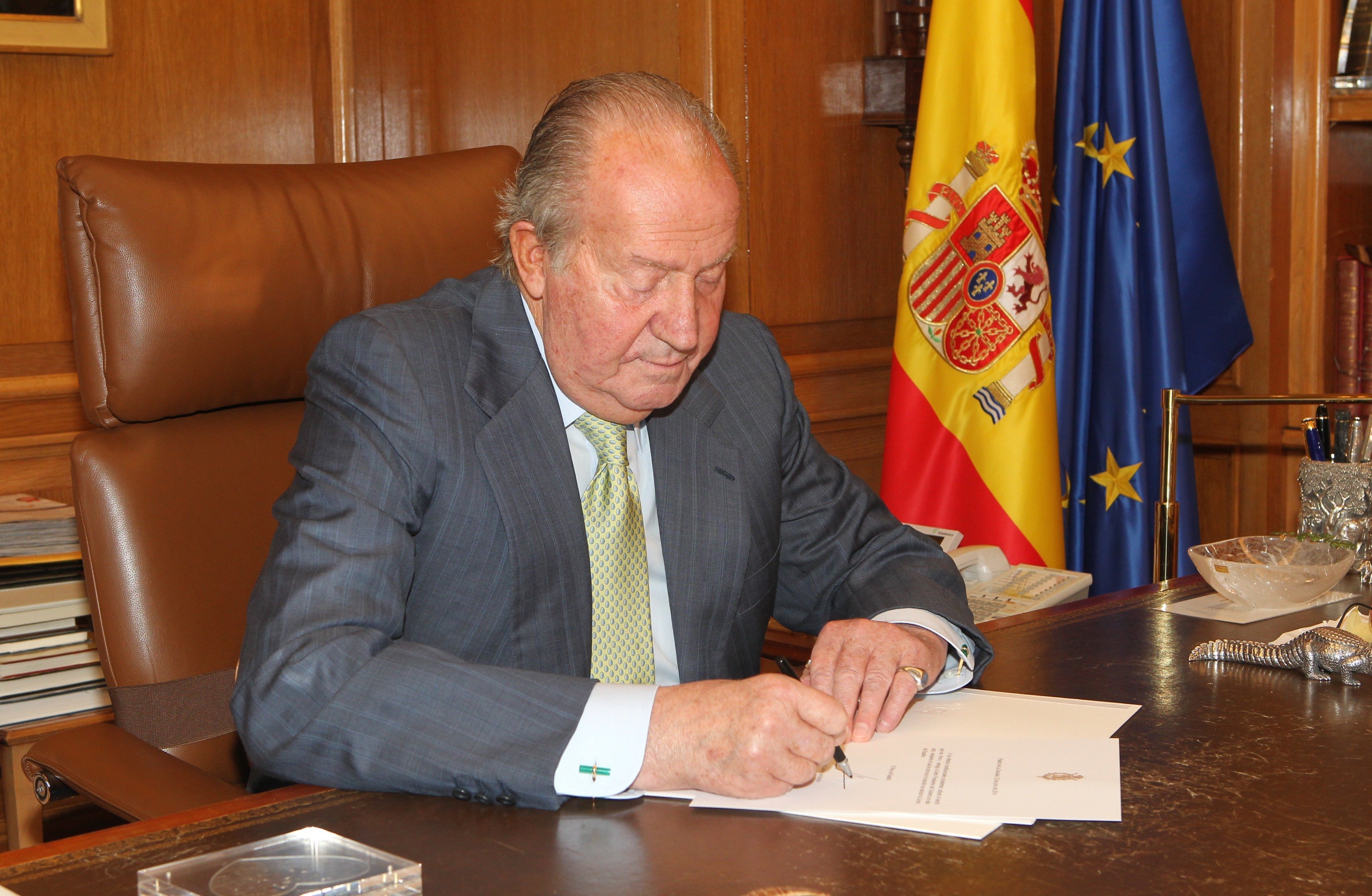 El rey Juan Carlos de España firma documentos para confirmar su abdicación el 2 de junio de 2014 en Madrid, España. | Foto: Getty Images