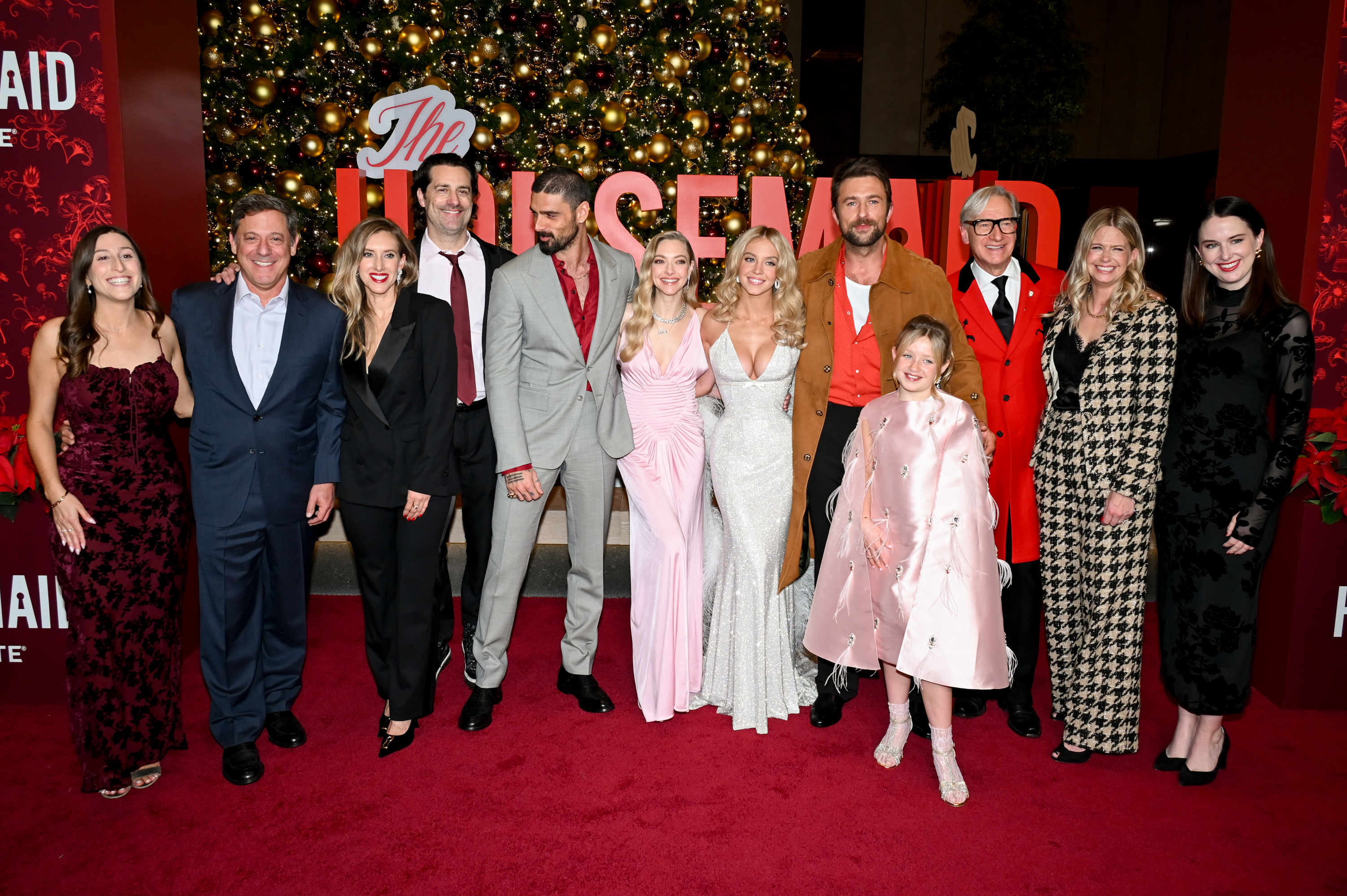 The full team behind "The Housemaid" gathers for a celebratory group shot, with stars Amanda Seyfried and Sydney Sweeney flanked by fellow actors, filmmakers, producers, and guests at the New York screening.