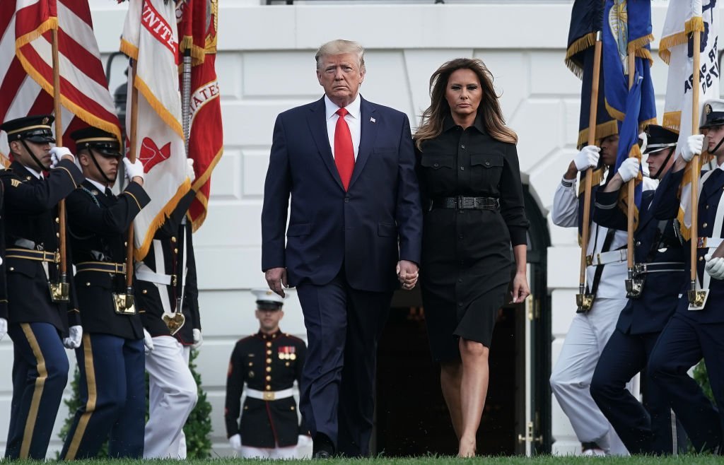 President Donald Trump and first lady Melania Trump come out from the residence to participate in a moment of silence at the South Lawn of the White House. | Source: Getty Images