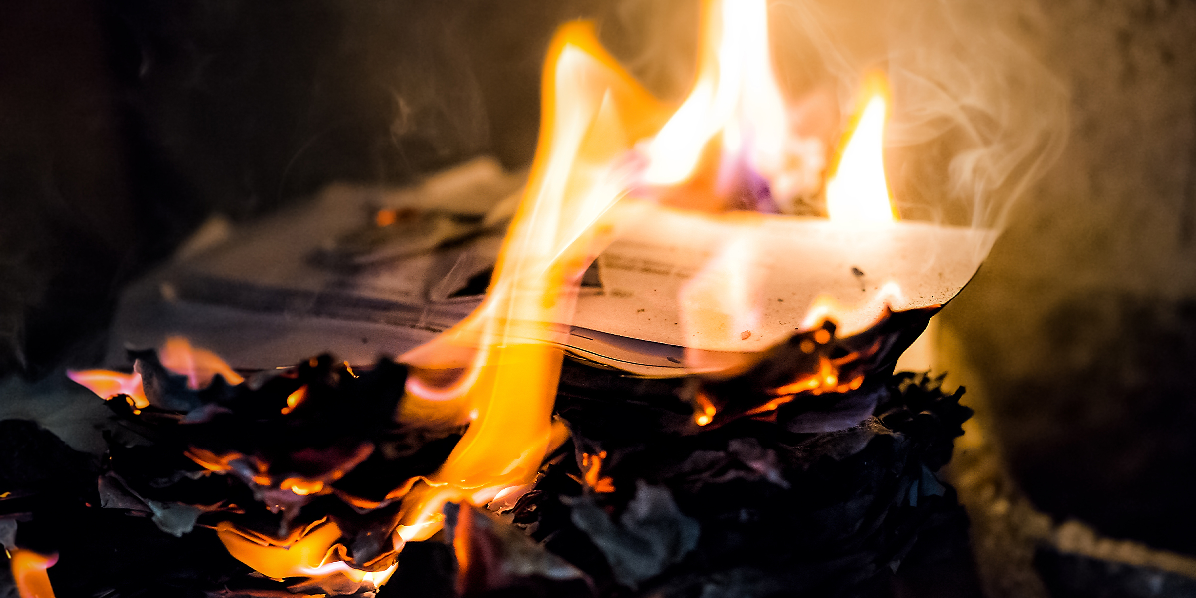 Letters burning in a fireplace | Source: Shutterstock